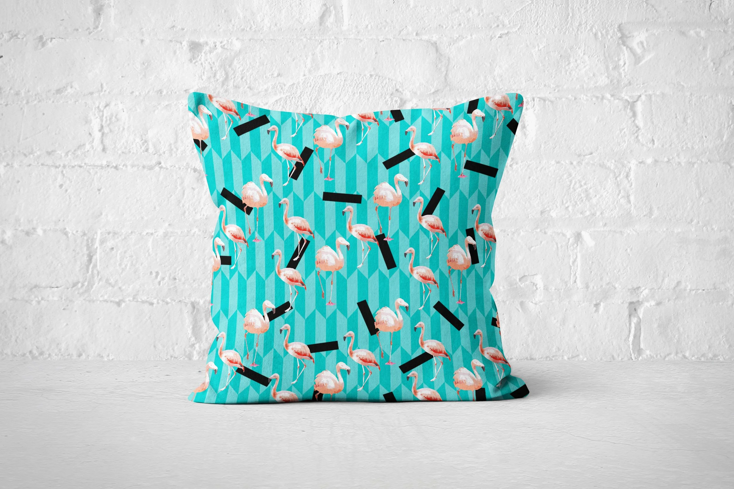 Taffy Flamingos - Pillow on Floor (Brick Wall Background).jpg