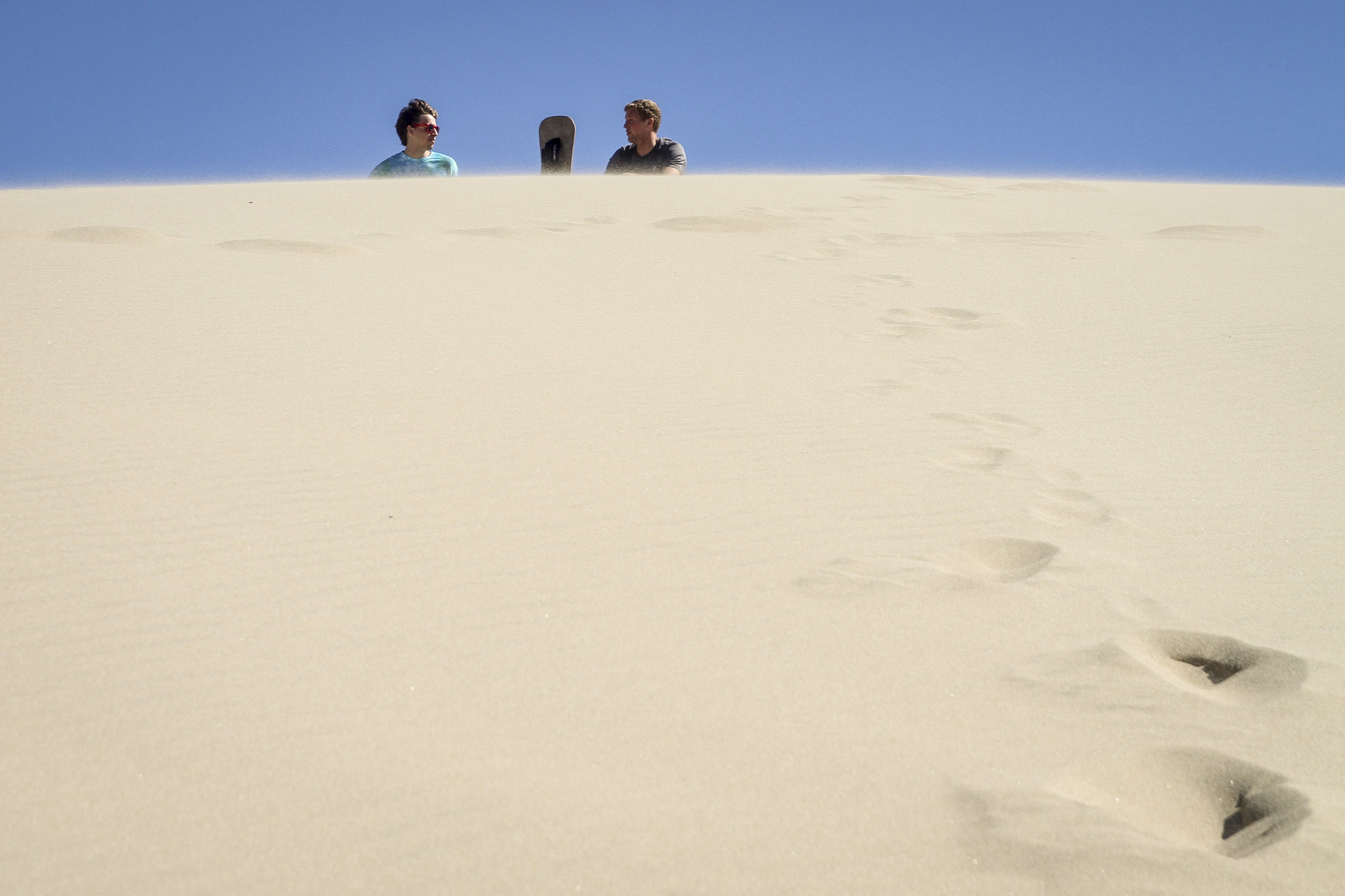 Sandboarding down classic Oregon sand dunes.
