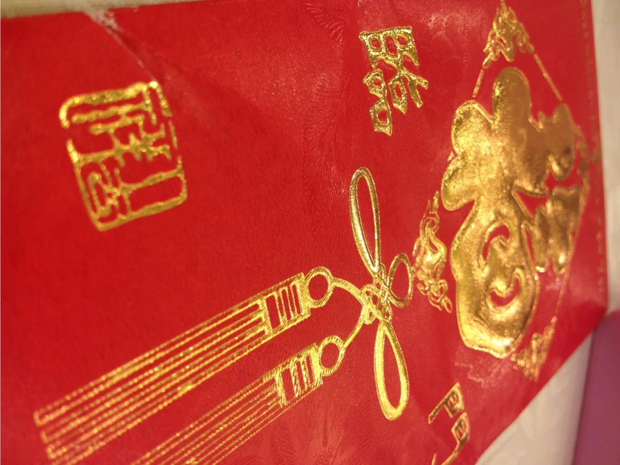 Instead of actual gifts guests give the married couple money in these traditional red envelopes and write a personal note on the back