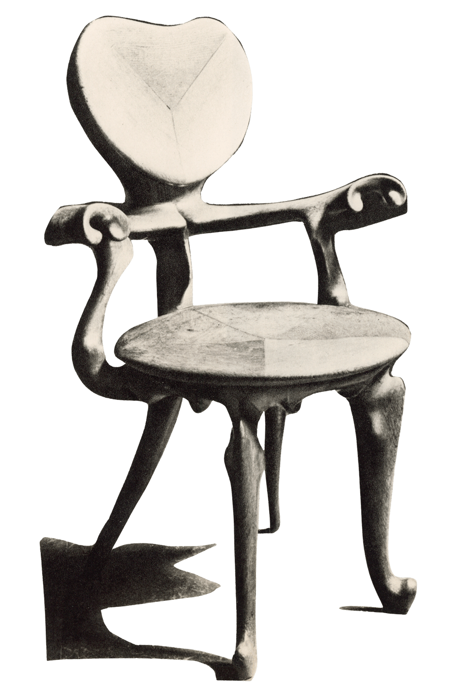 Black and white photograph of a wooden chair with an artistic, abstract design, featuring a uniquely shaped backrest, curved armrests, and four differently shaped legs.