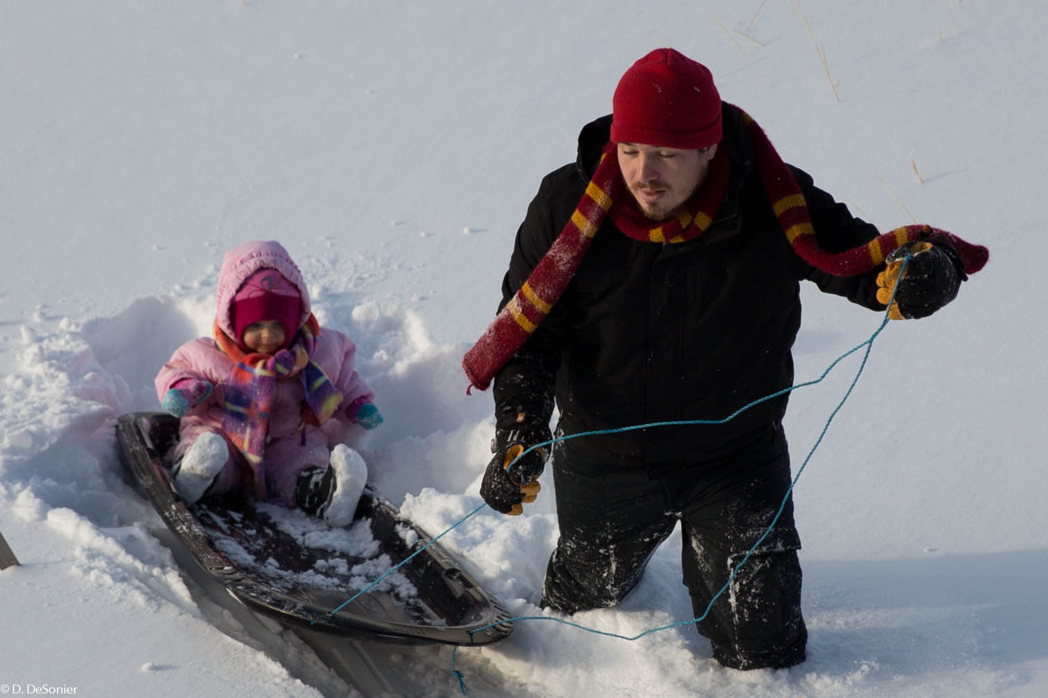 Uncle Mike taking Rosie sledding.