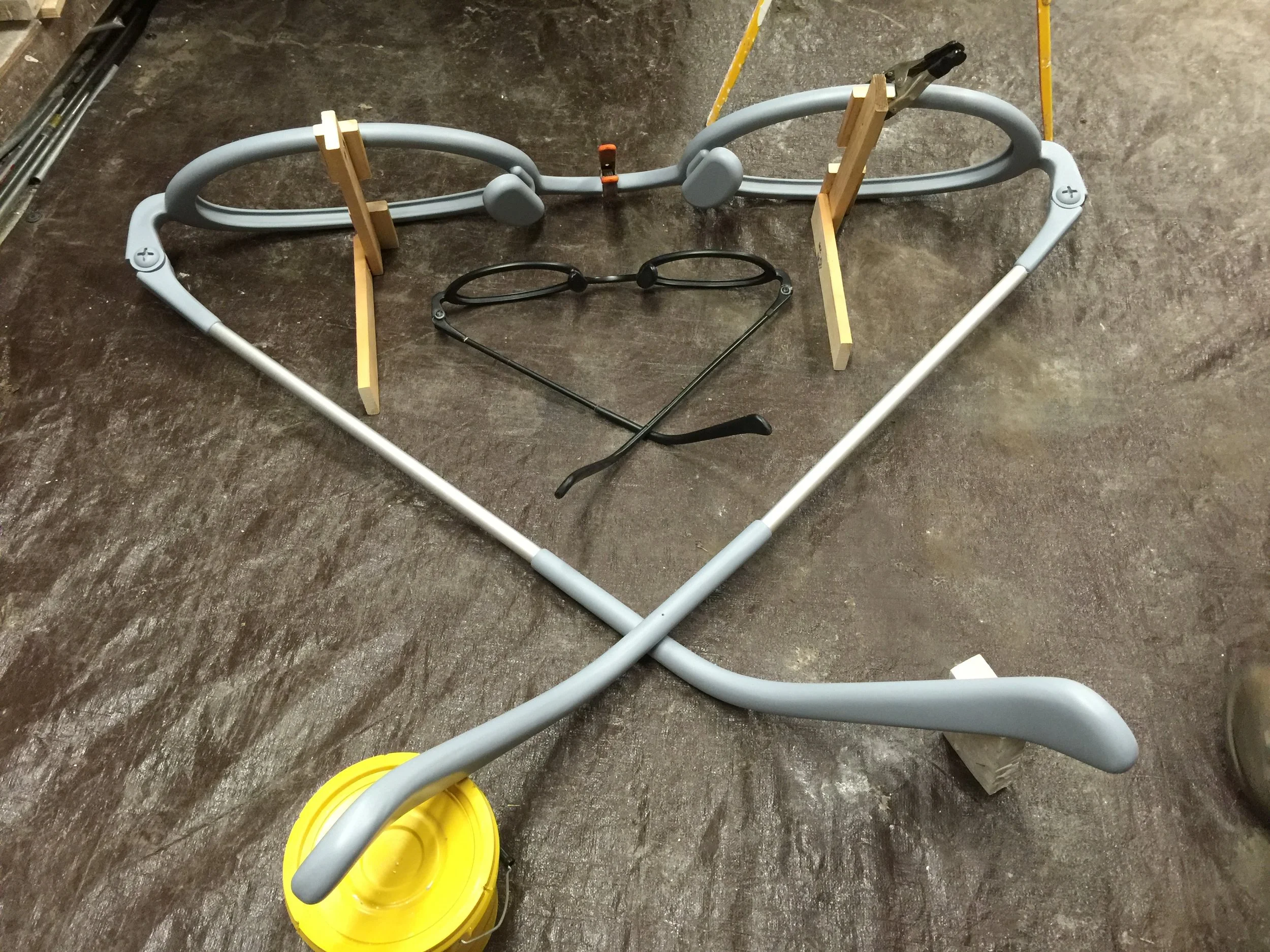  Small black glasses were the first prototype.&nbsp; The enlarged gray glasses were 3D printed and finished by hand. Photo by Shelly Bradbury 