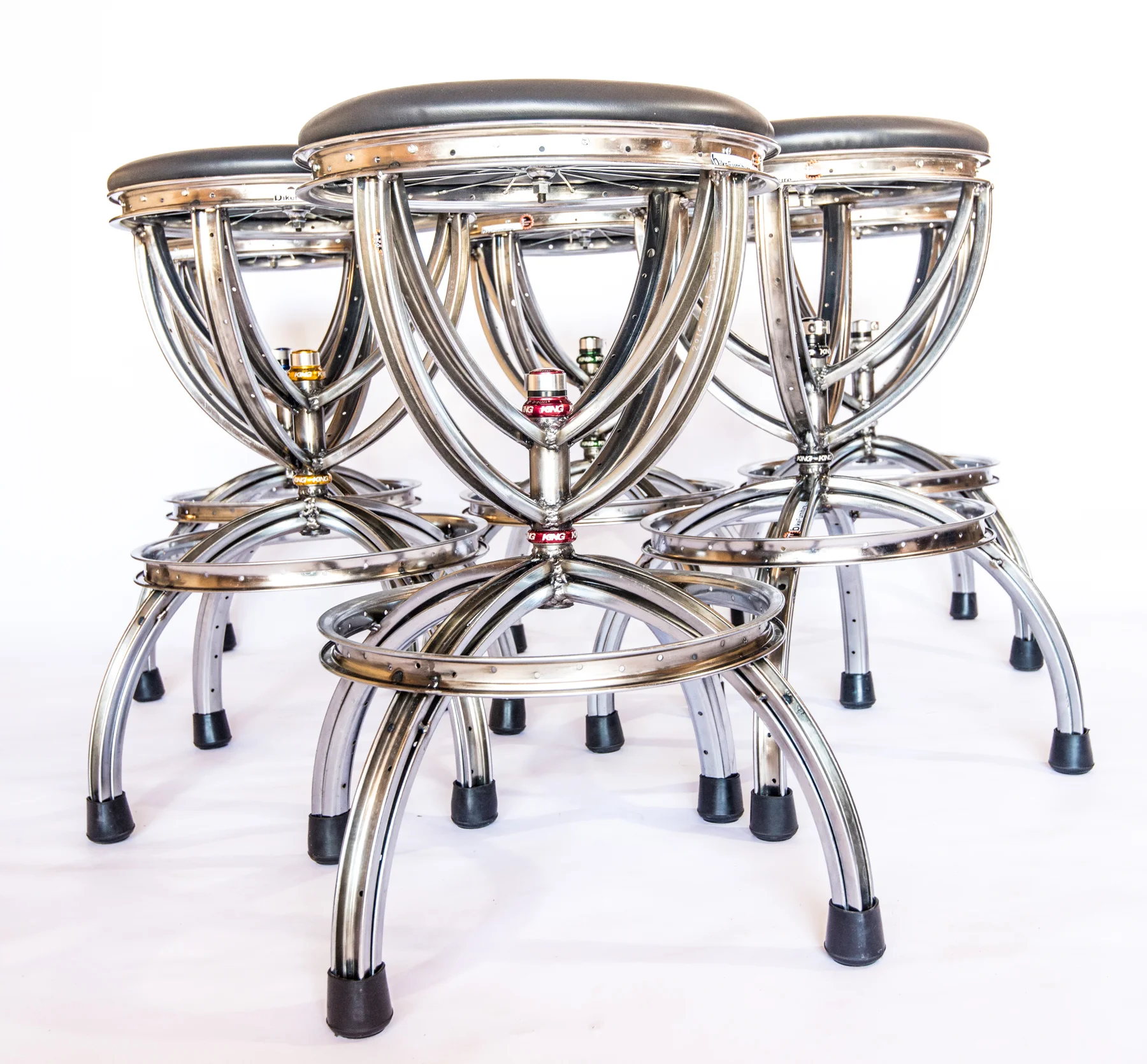 Crown swivel Barstool (shown with black cushions) Swivel mechanism is the headset bearing component (available in colors) from a bicycle. Can also be made with a back.