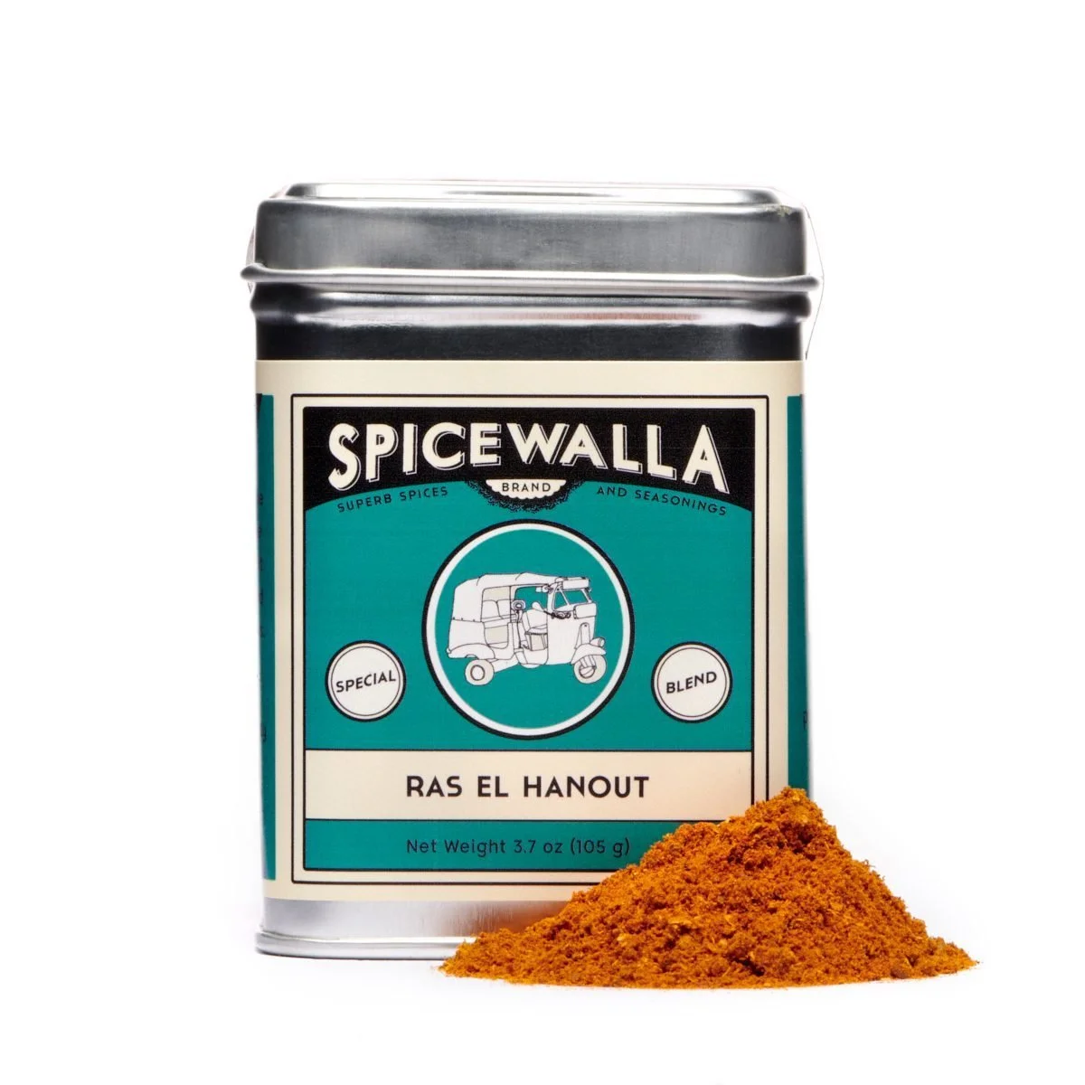 A teal spice tin beside a pile of ras el hanout on white.