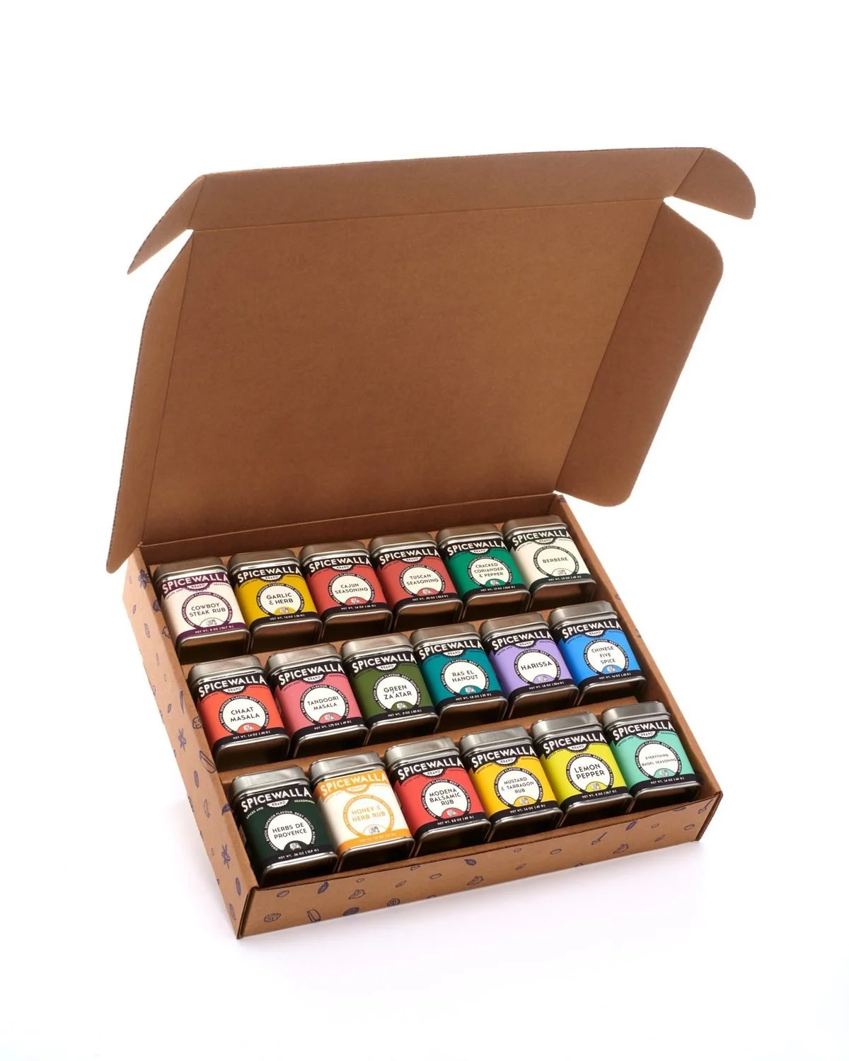 An open kraft gift box holding three rows of colorful spice tins.