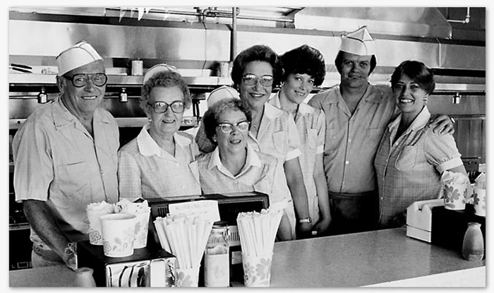 Store Manager, Carol Kelly (shown third from right), was hired in 1972 and is the current manager today. She is also pictured above with her co-worker (and daughter) Victoria. 