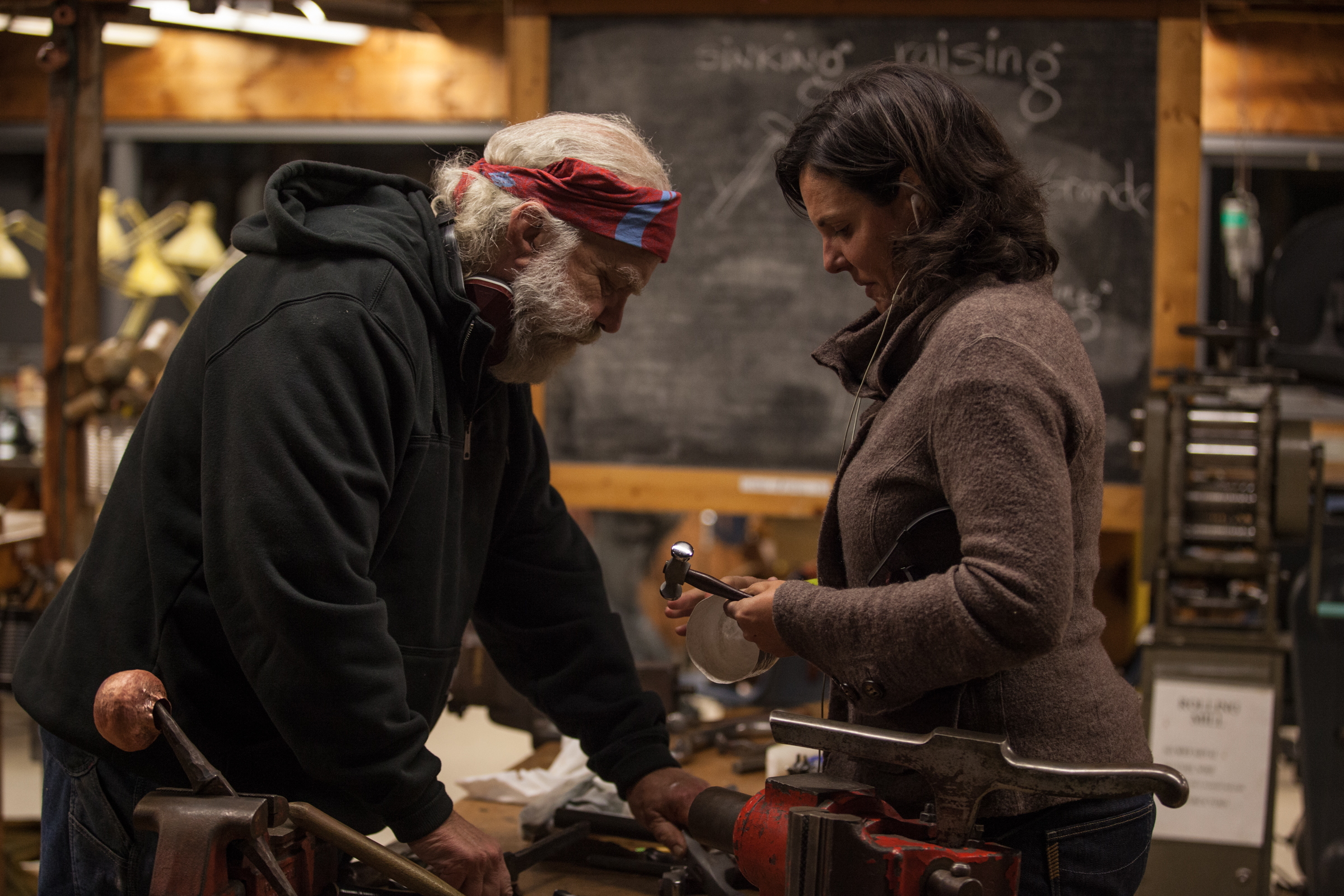 Greg Wilbur engaging with Ann Stafford in the metal shop. Two truly special humans.