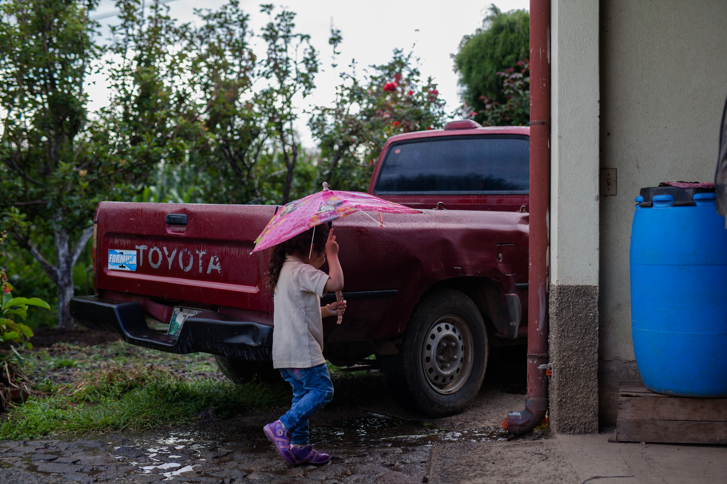 Sophie, Marco and Carolina's cute three year old daughter. Seen her playing in her front yard during the rain. 
