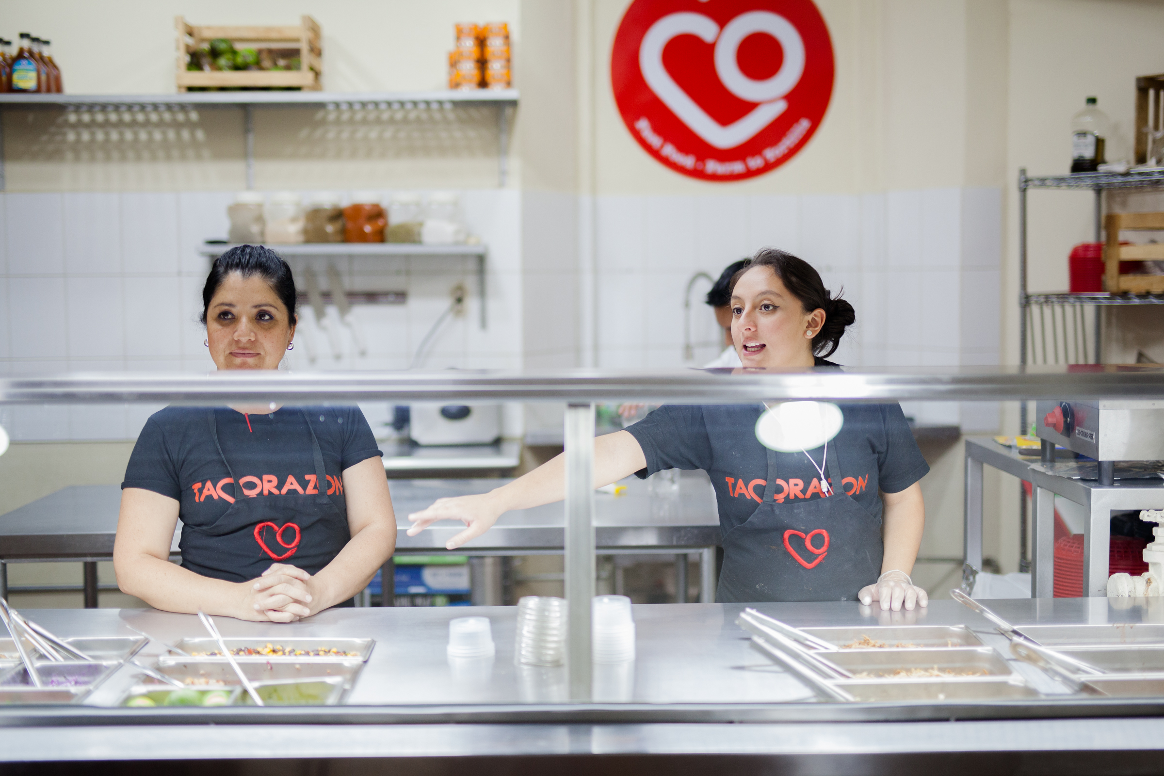 Karen (left) and Eva (right) greeting and informing new customers to Tacorazon for dinner.