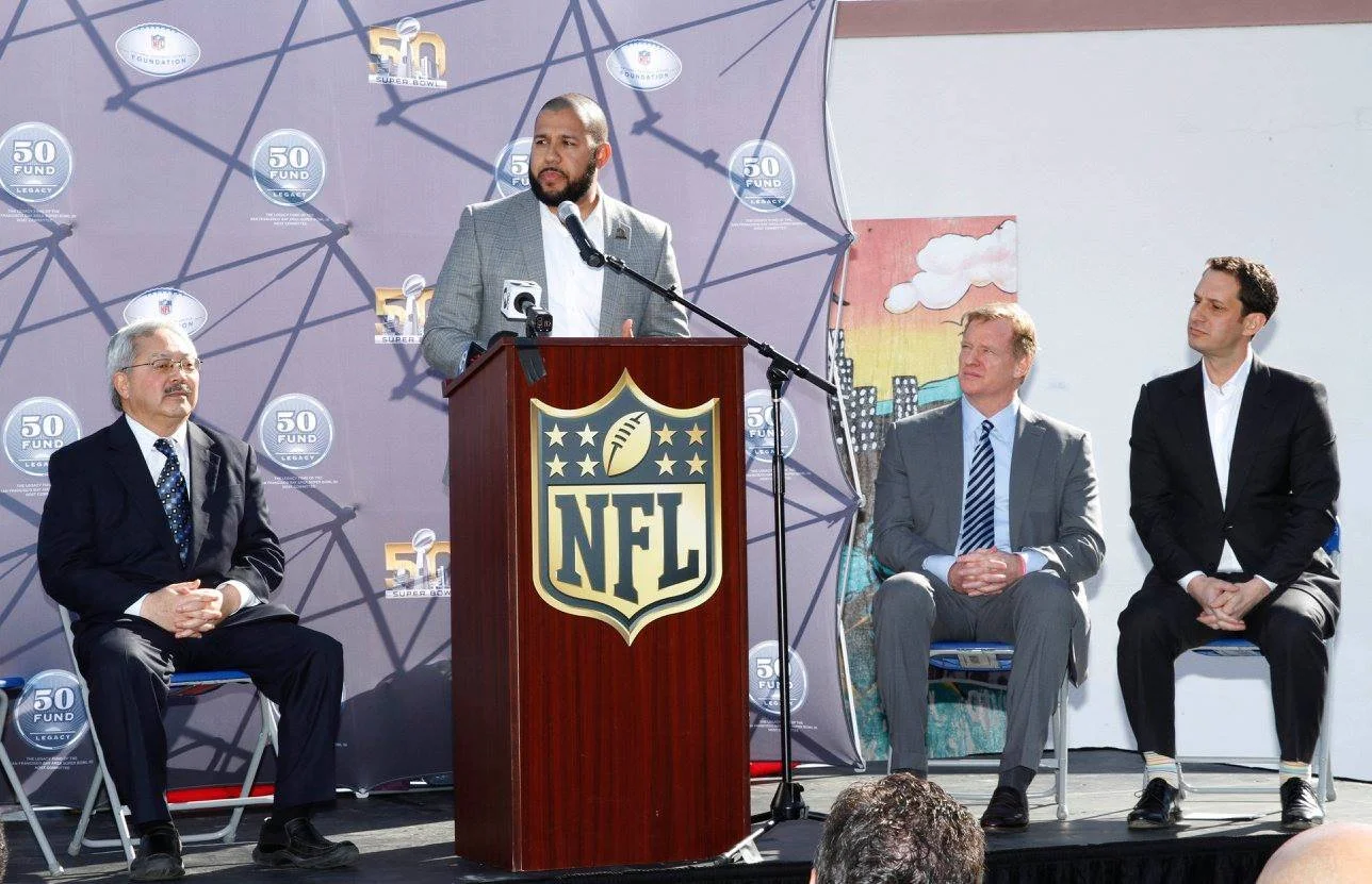 ason Trimiew speaking at an NFL Super Bowl 50 press conference.