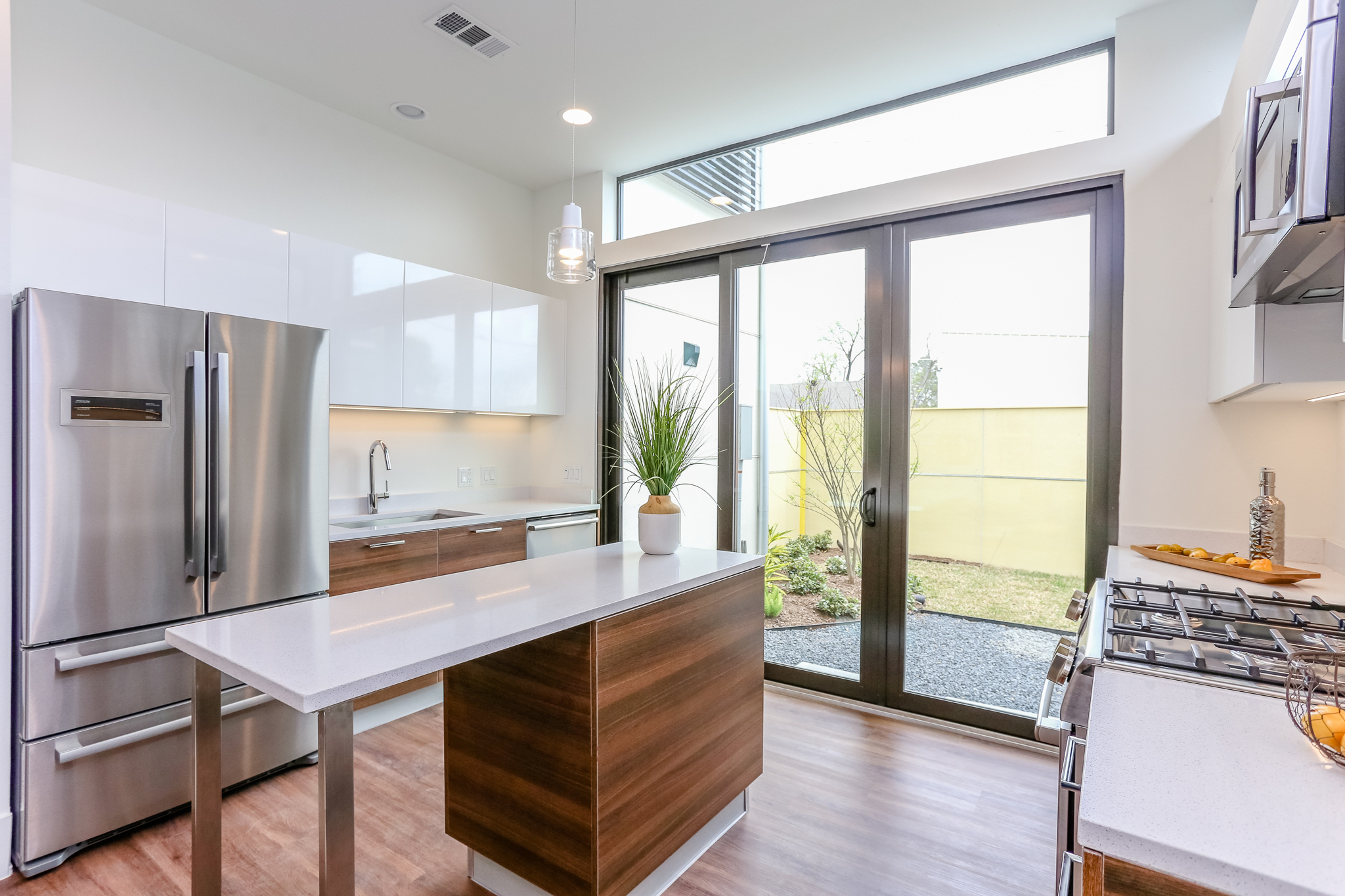 Entertaining is a dream in this ultra-modern kitchen which includes a Bosch stainless steel appliance suite, Moen faucet and sleek Madeval European styled cabinetry with soft-close hinges.