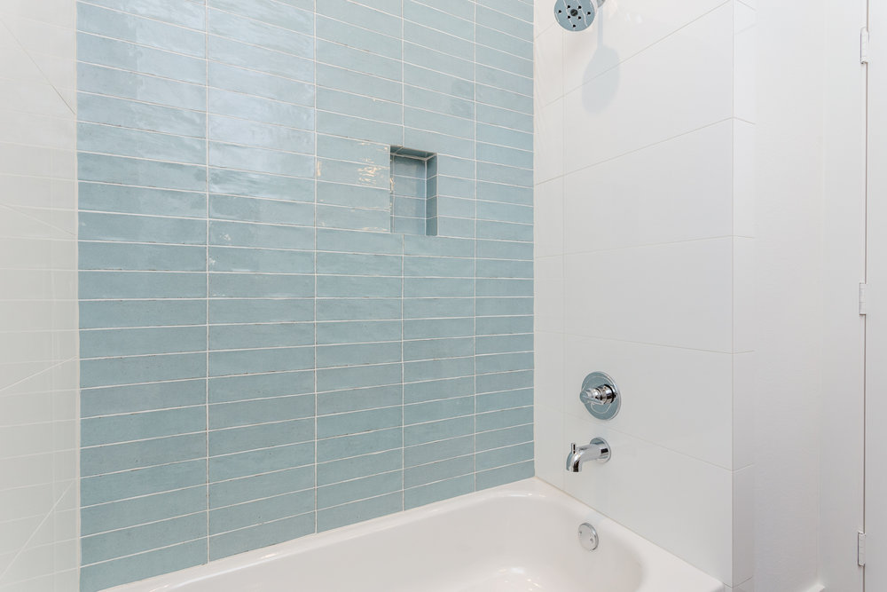  The hall bath is thoughtfully designed with in-wall storage in the tub/shower. 