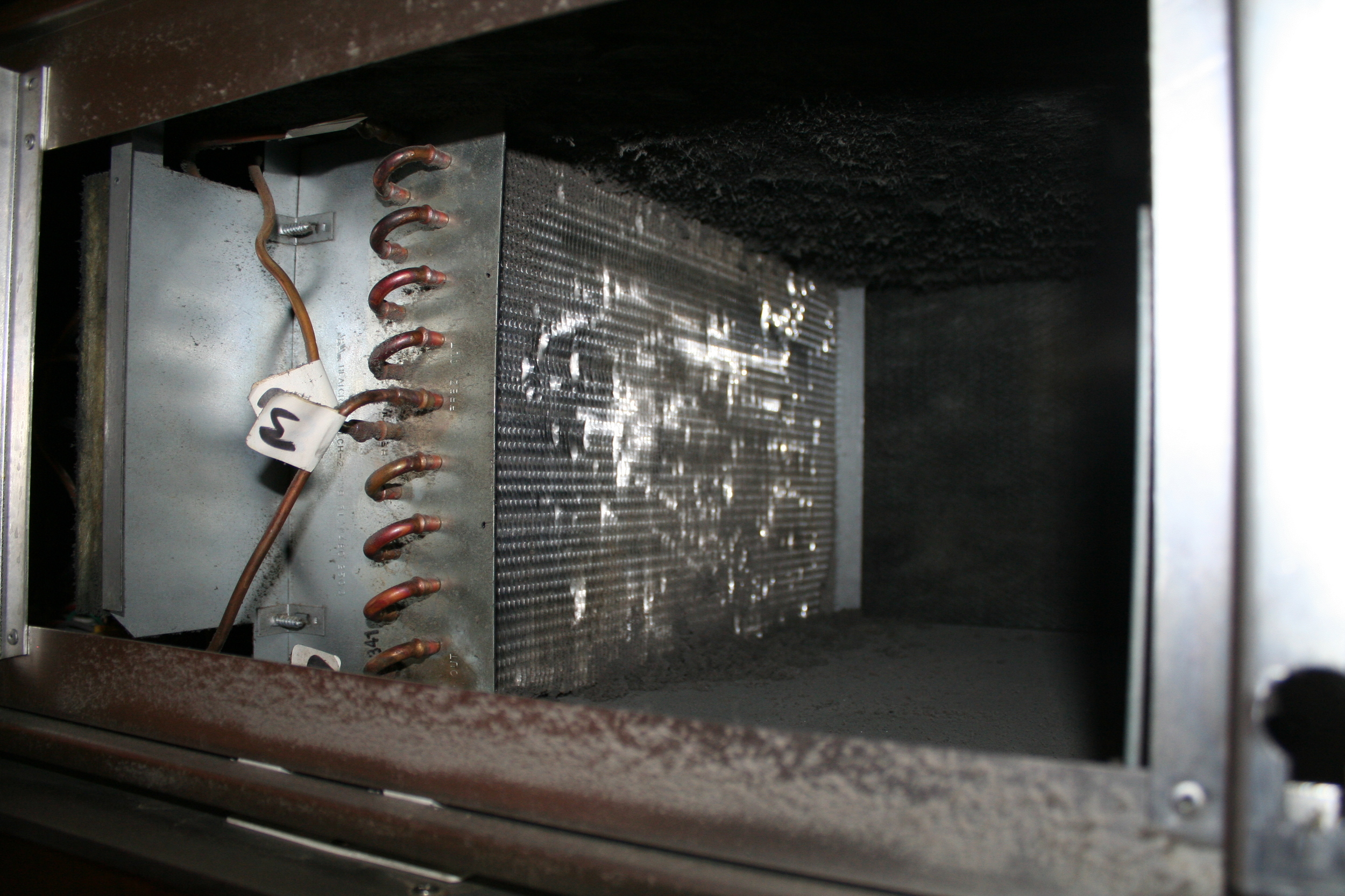 The refrigerator condenser fins before...