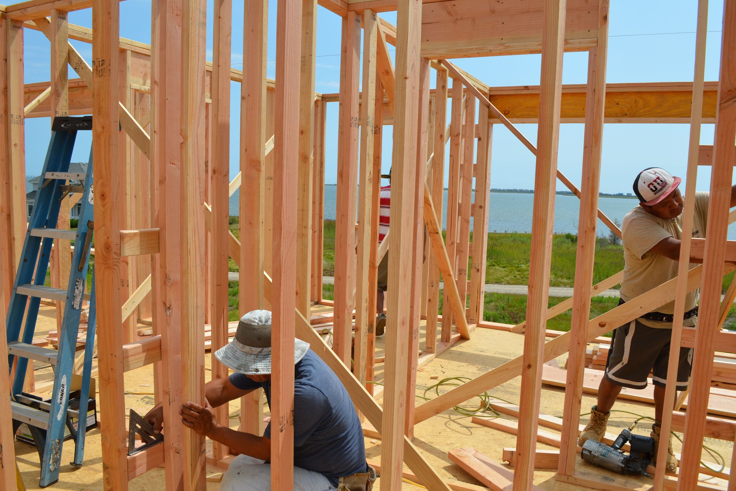 Framing Crew Working on Ladder Blocking