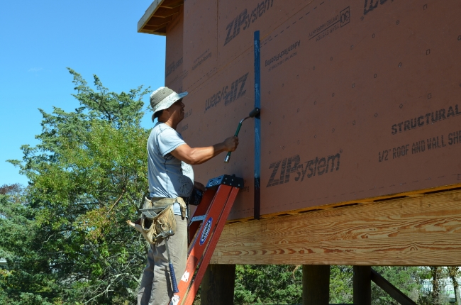 ZIP System sheathing comprising regionally grown, harvested and manufactured wood content