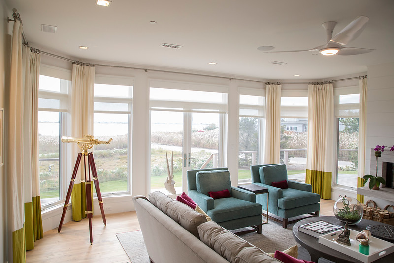 Solar shades from The Shade Store use high performance fabric from Phifer to control solar heat gain. Somfy motors tie into Sunset Green Home's Elan g! home automation system