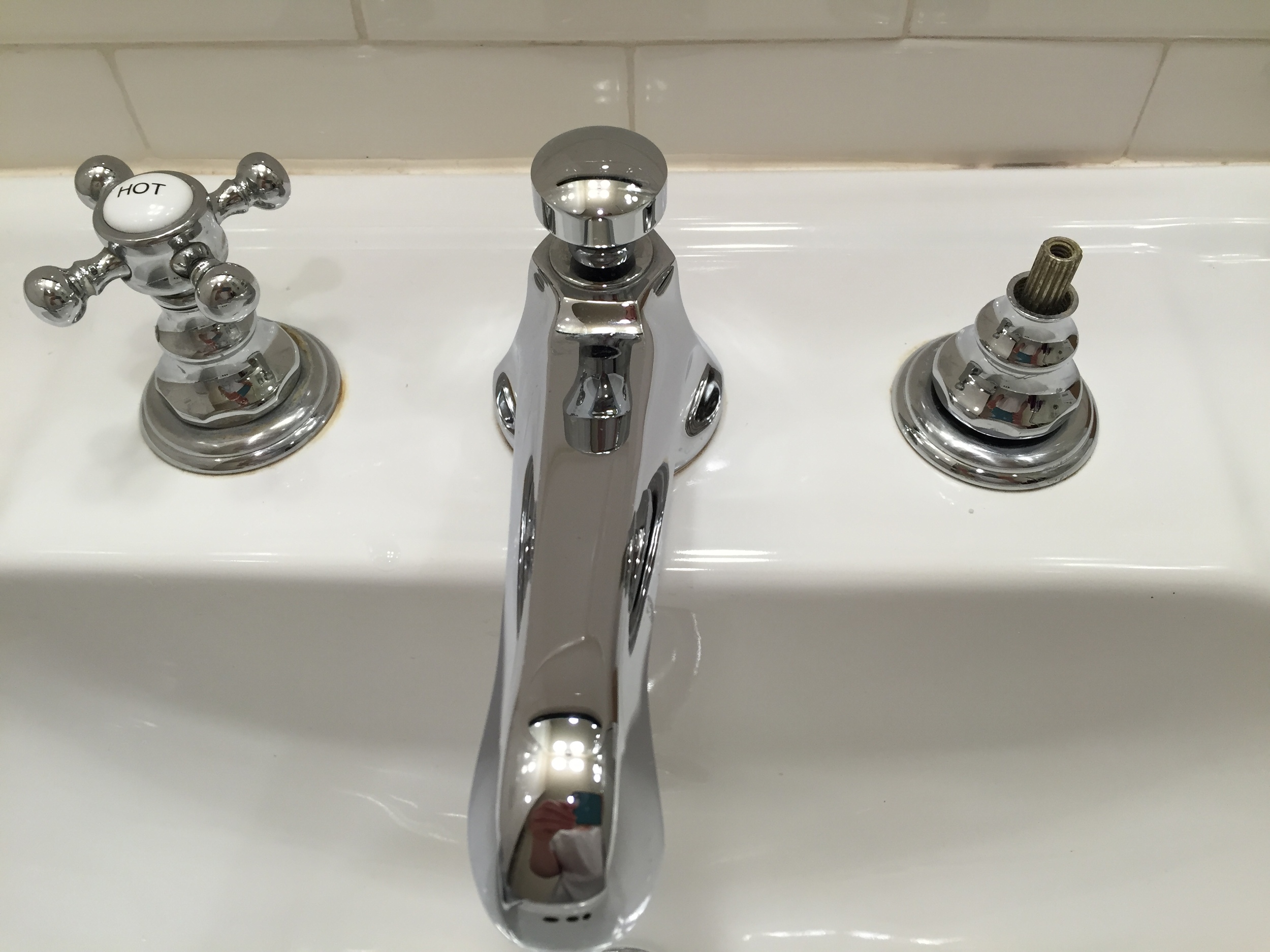  Faucet handle removed using an Allen wrrench to loosen two set screws... 