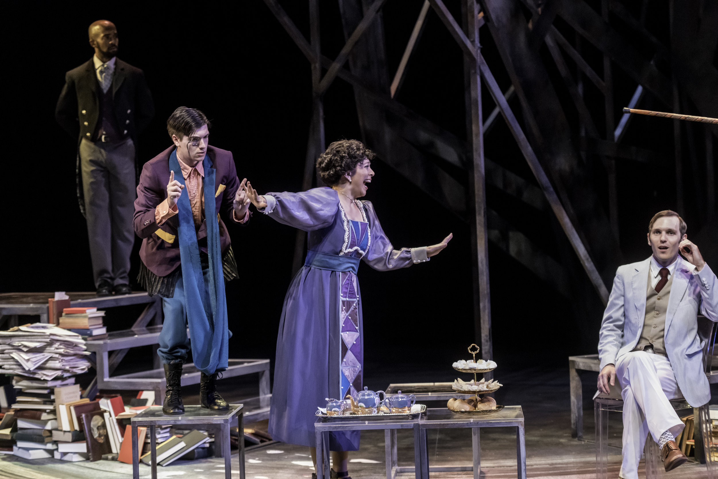  As Gwendolyn,&nbsp;cutting off Tzara (Kevin Blair) as Henry Carr (Chris Sheard) and Bennett (Jordan Gleaves) look on. Oh, and the entire scene is in limerick form.&nbsp;Travesties | by Tom Stoppard | at Krannert Center for the Performing Arts | Dire