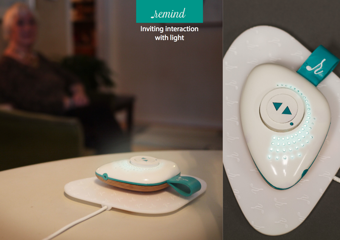 Clean and bright interaction area with inviting light at the top. Warm and natural, wood-like material at the bottom, pleasant for the user to hold. Charged with the conductive charging base.