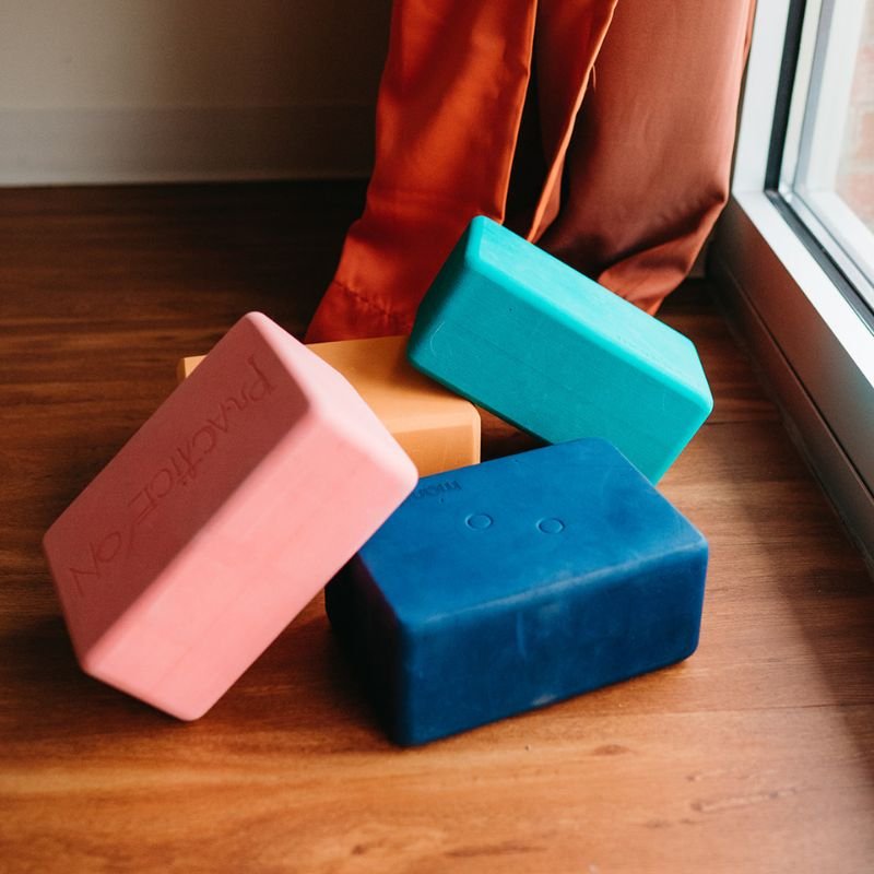 Stack of yoga blocks used as yoga props for support, strength training, and movement exploration.