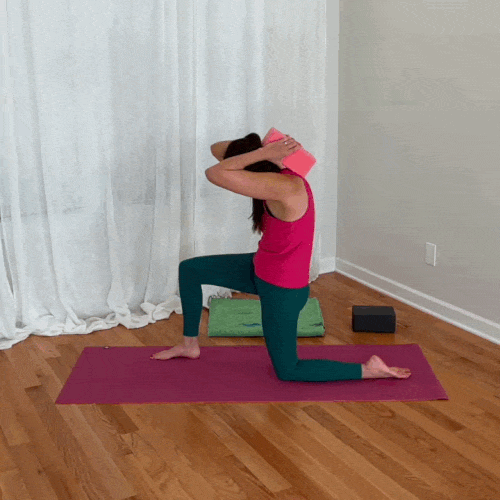 Jenni demonstrates thoracic extension by leaning her upper back over a yoga block.
