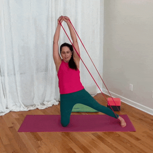 Jenni demonstrates active thoracic lateral flexion, side bending while holding a resistance band anchored to the side.