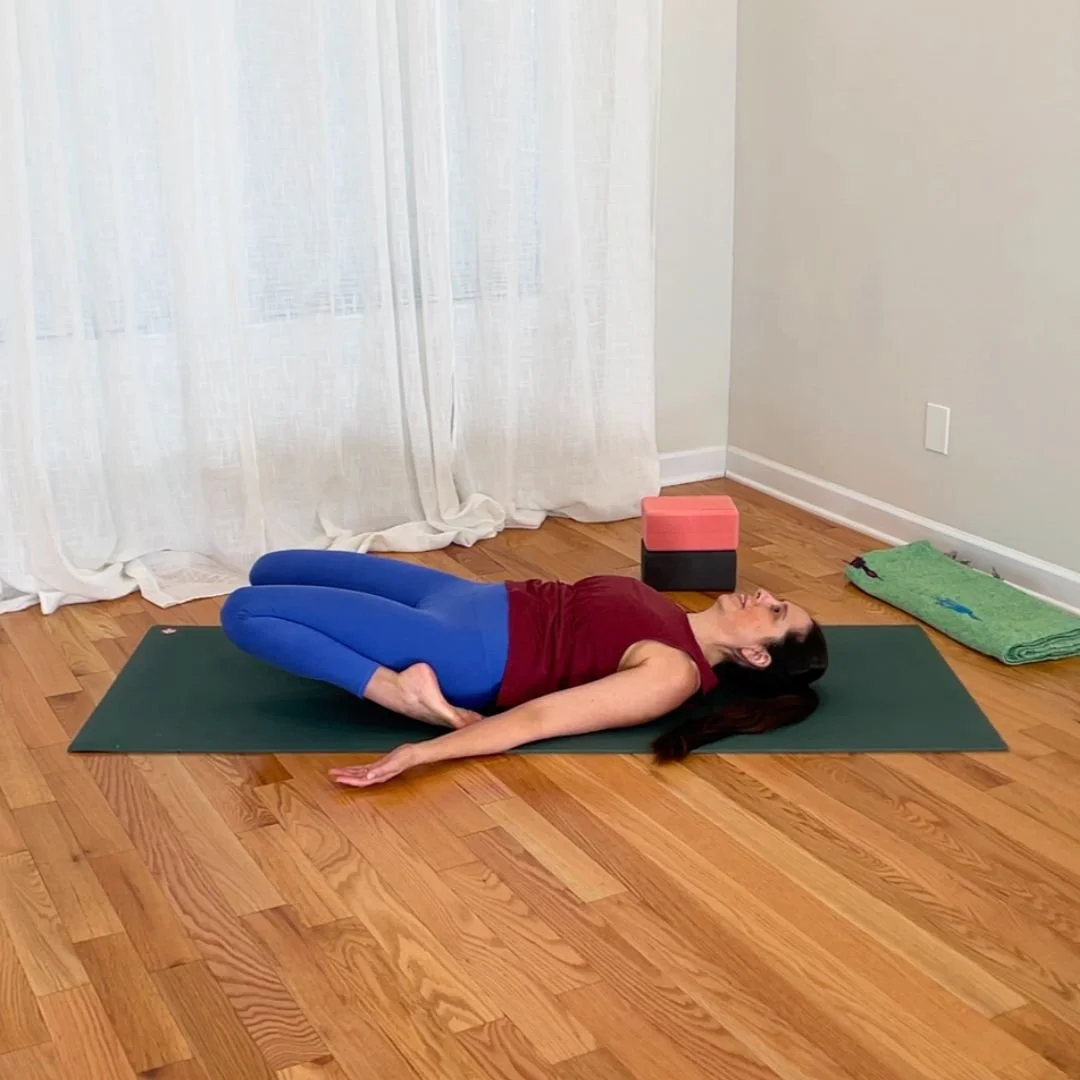 Reclining hero pose variation with knees lifted away from floor