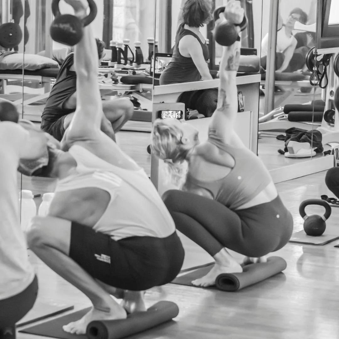 yoga pose malasana with a kettlebell