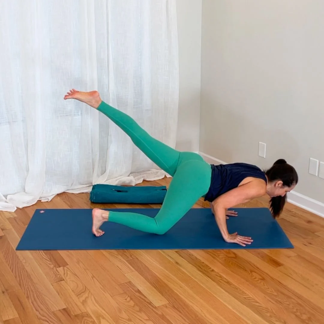 Yoga teacher practicing a challenging low-to-the-ground yoga strength movement