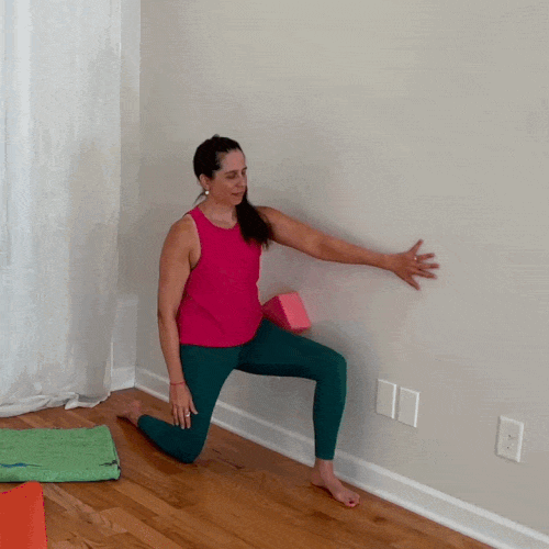 Jenni demonstrates a wall windmill for thoracic rotation, rotating her upper body while keeping her hips relatively still.