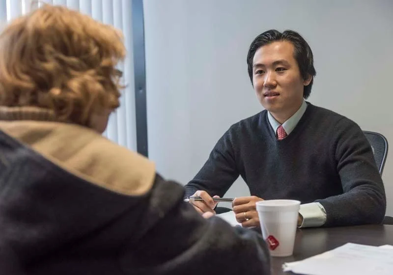 ONE ON ONE: Dr. John Luo, founder of Doctor's Choice, counsels Dorothy Verrier of Warwick on Medicare plan options. PBN PHOTO/ MICHAEL SALERNO