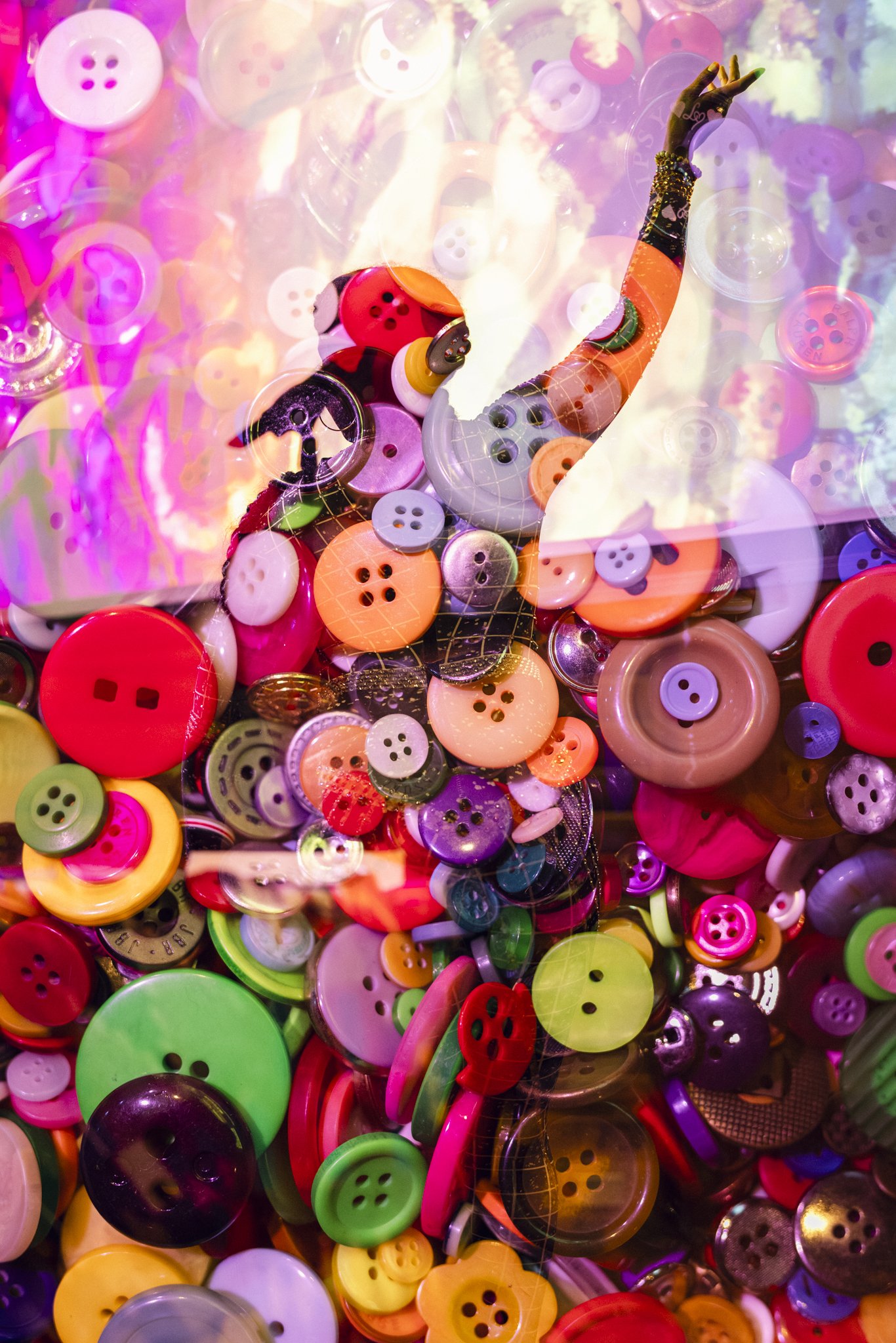 An abstract composition of various colorful buttons overlapping each other with a semi-transparent surface creating a layered appearance.