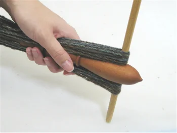Next, gently tap one of the arms on a table or other hard surface to partially remove it from the center post.
