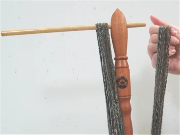 Once you have partially removed one of the arms, the yarn will easily slide off of the niddy noddy.
