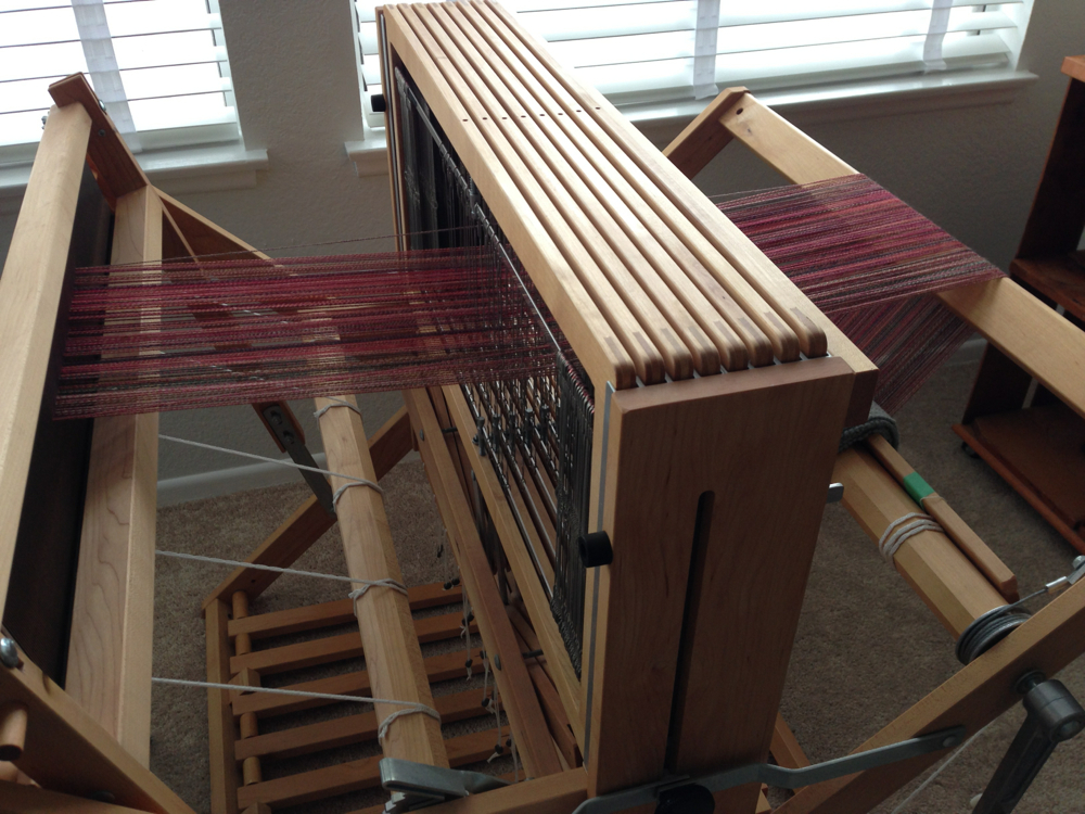My Schacht Baby Wolf loom in the process of being warped with some of my handspun yarn