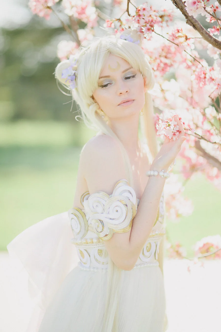 'Sailor Moon' has been one of my biggest influences growing up. The series taught me to believe in myself and to love deeply. Whenever I was afraid I would imagine that I was a Sailor Scout with magical powers! So it is no surprise that I have dreamed of making Princess Serenity's gown. I was so deeply inspired by the Dior gown that Naoko Takeuchi drew inspiration from, and thusly I wanted to create a hybrid of Takeuchi's and Dior's concepts. I knew that my childhood friend Laura (who loves the series like I do) would be the perfect model for this design, and that Emma Rolos of Honey Honey Photography was the woman to photograph this gown. I enlisted the help of hair stylist Chloe Doan for the wig and was fortunate to work with one of my favorite makeup artists Megan Joy . I hope that this shoot enchants you as much as it does me, and that it brings you back to the etheric beauty of the Moon Kingdom. All photos © Creature of Habit and Honey Honey Photography do not use without permission