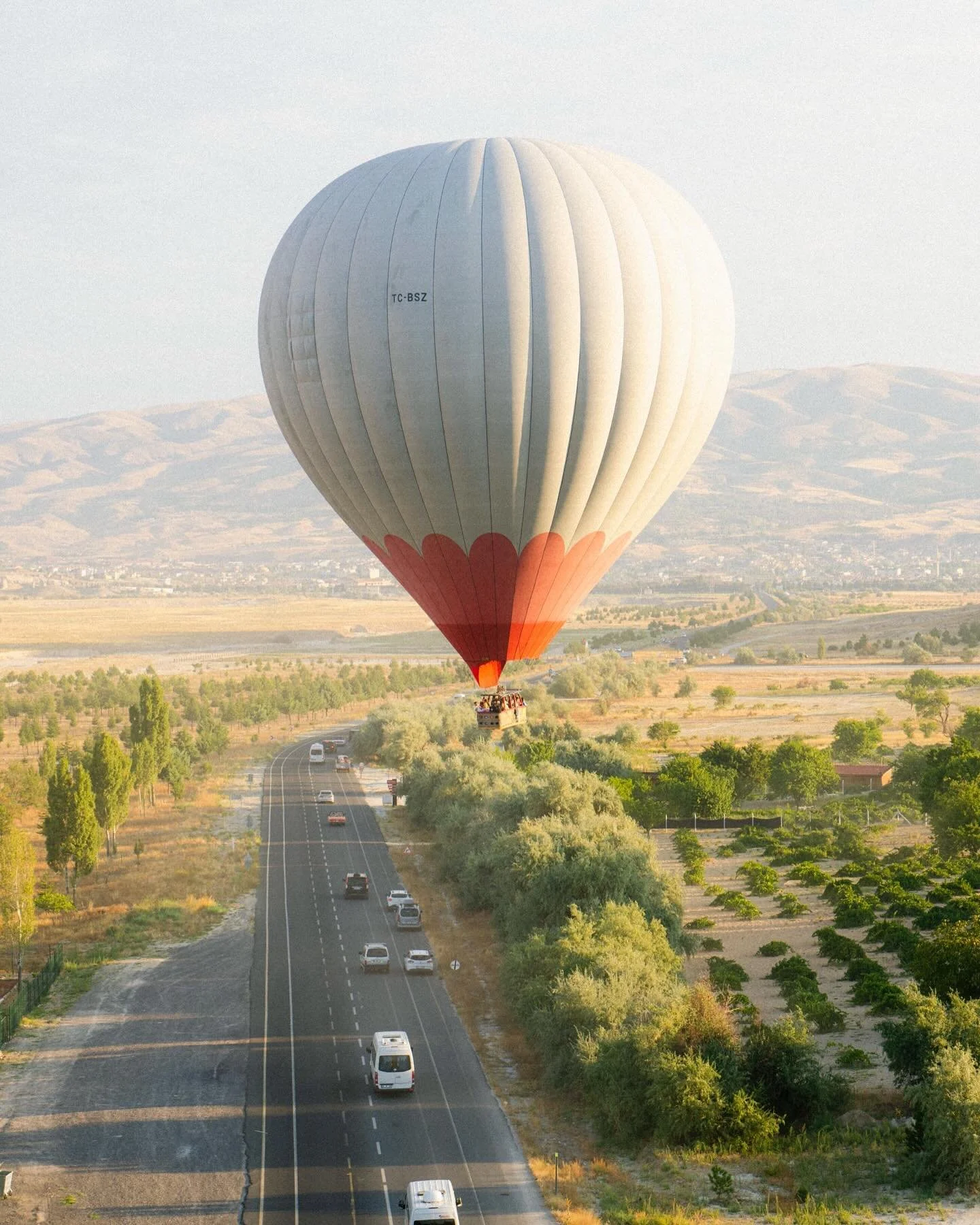 Floating above the winding roads of Cappadocia as the morning light paints the landscape in gold 🎈