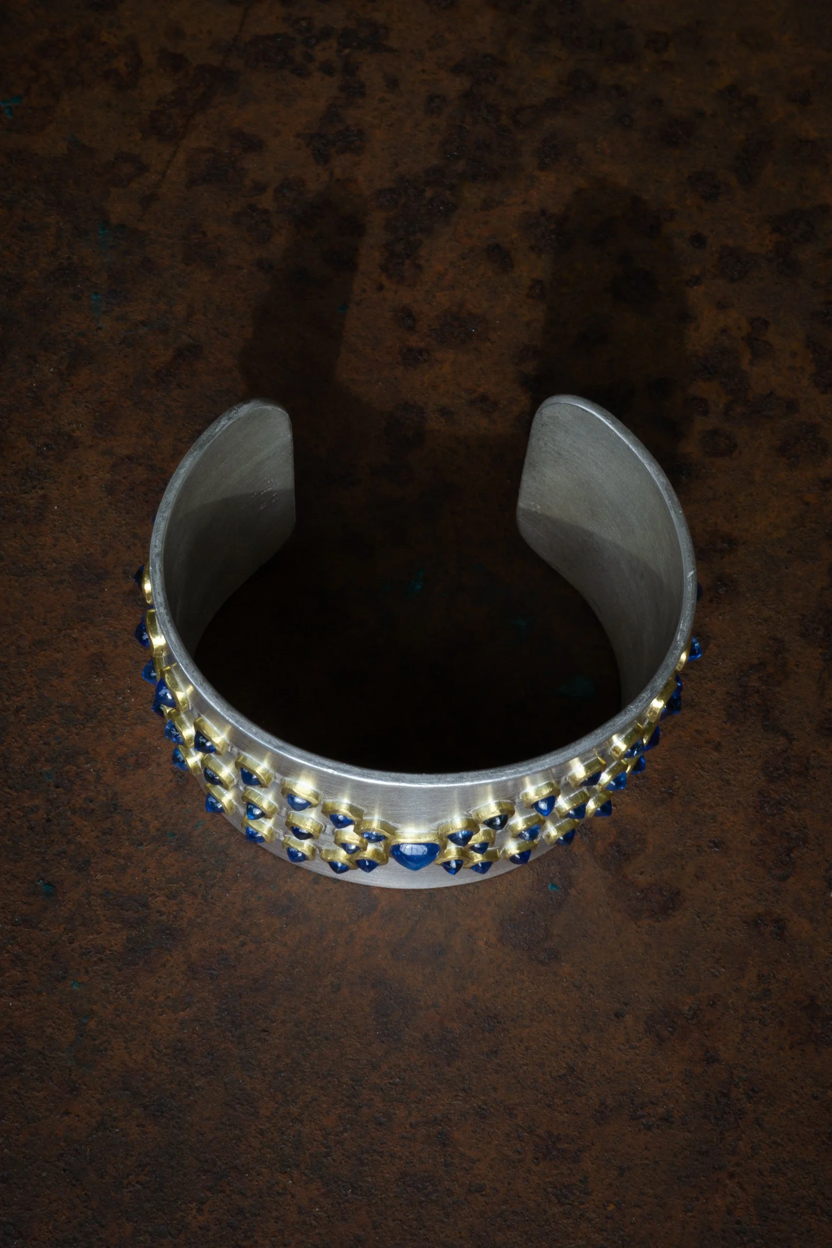 Alcyone Cuff showing elevation of sapphires on the surface.