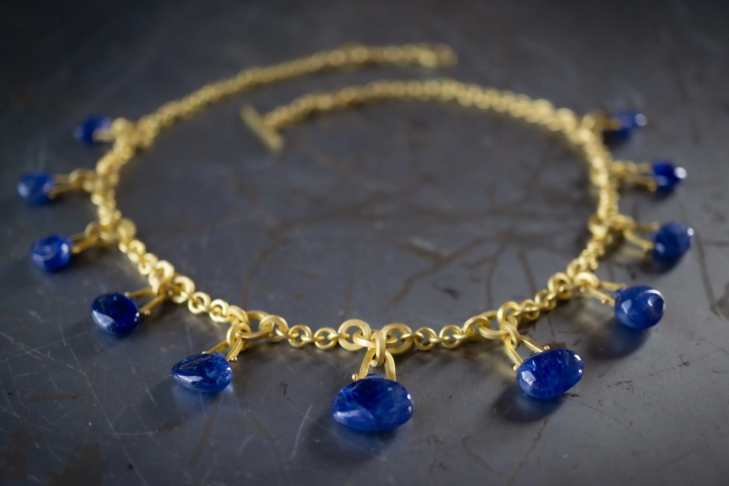 Tabiz Necklace in 22k gold with antique sapphires front angle.