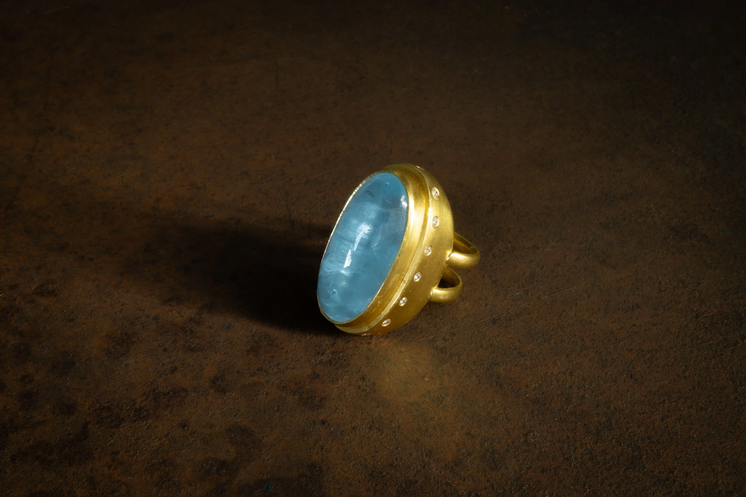 Galene Ring in 22k, shown at an angle on a tabletop.