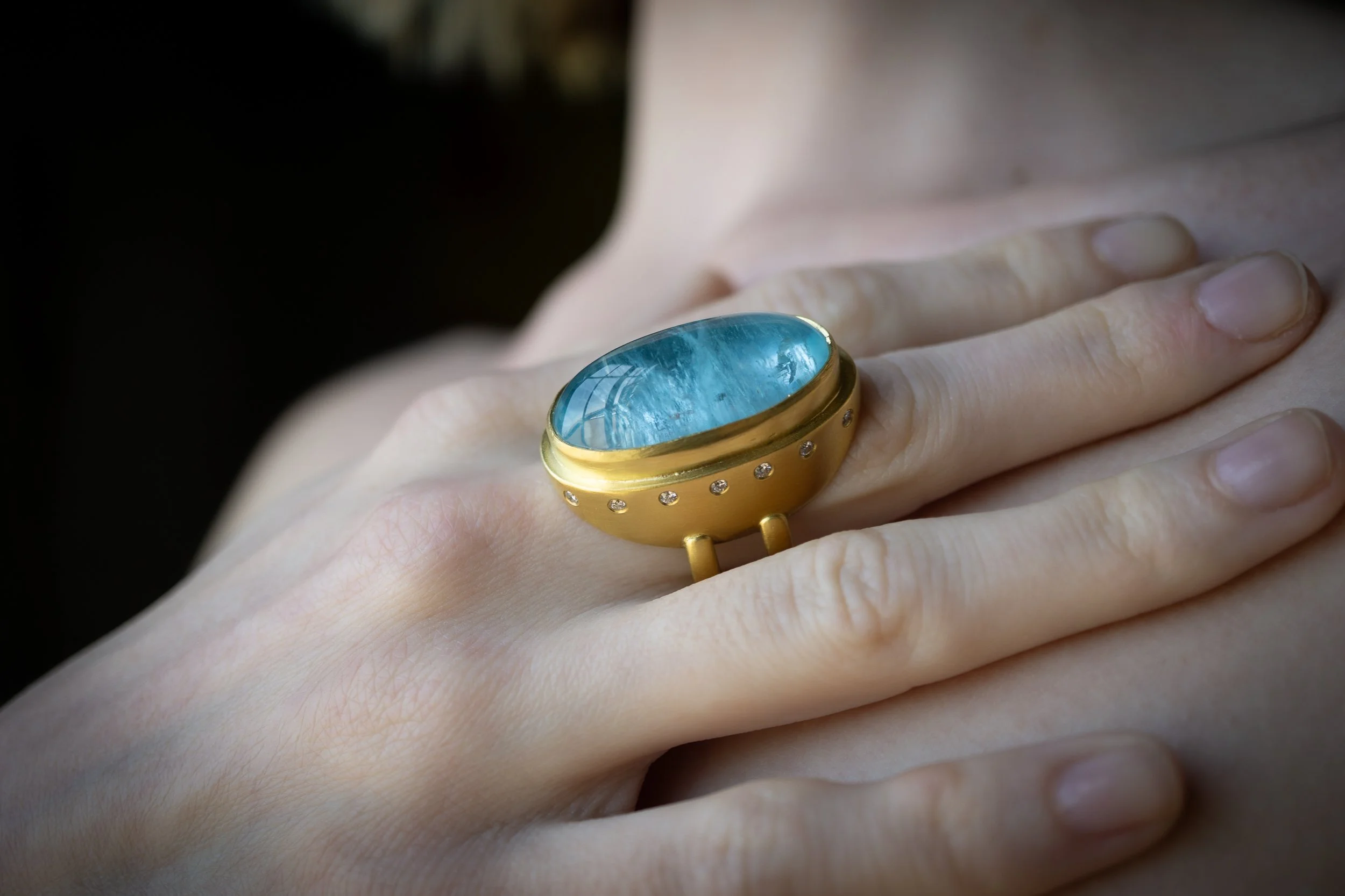 Galene Ring on the hand, showing window reflection in the stone.