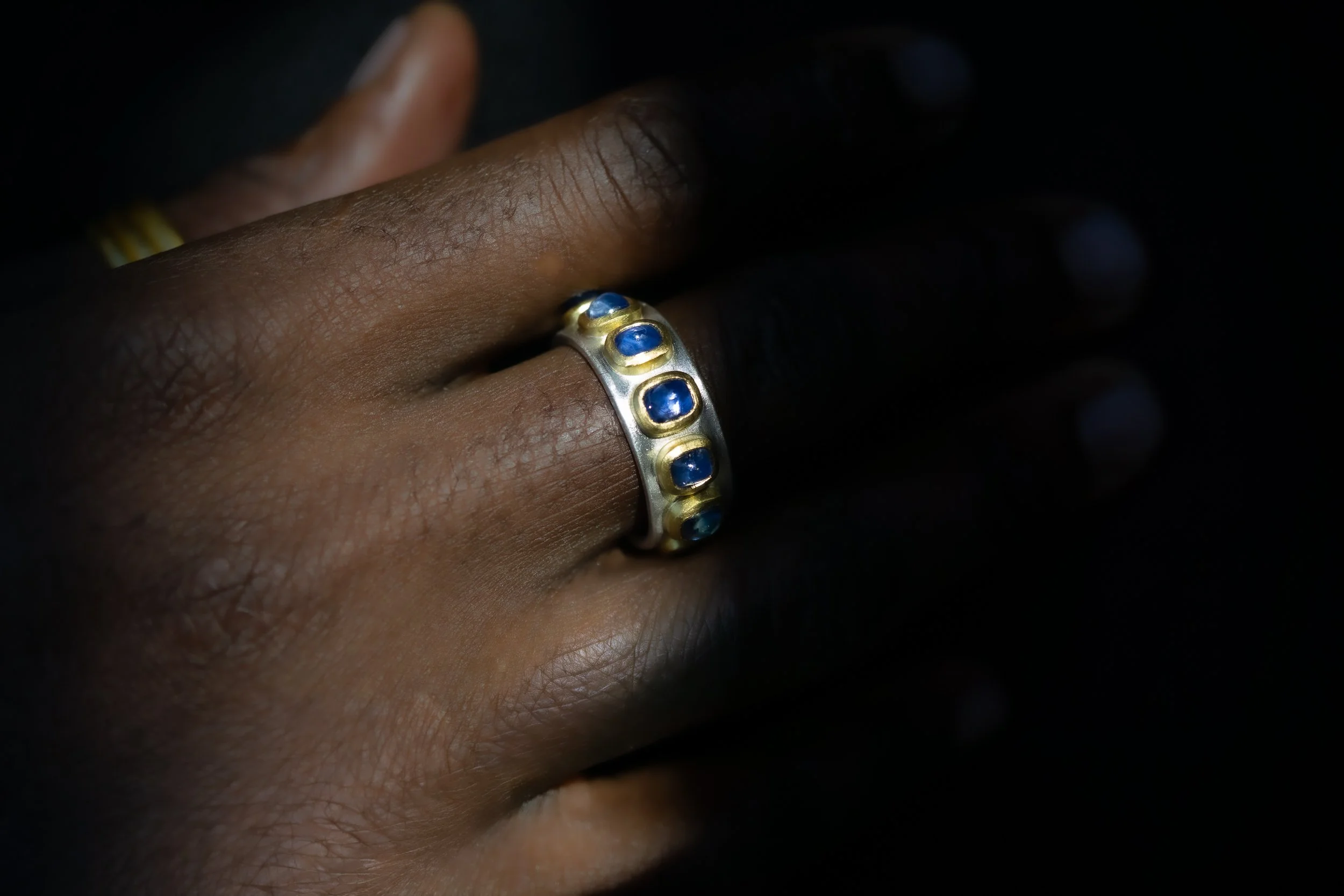 Pleiades Ring shown on the hand in shadow.