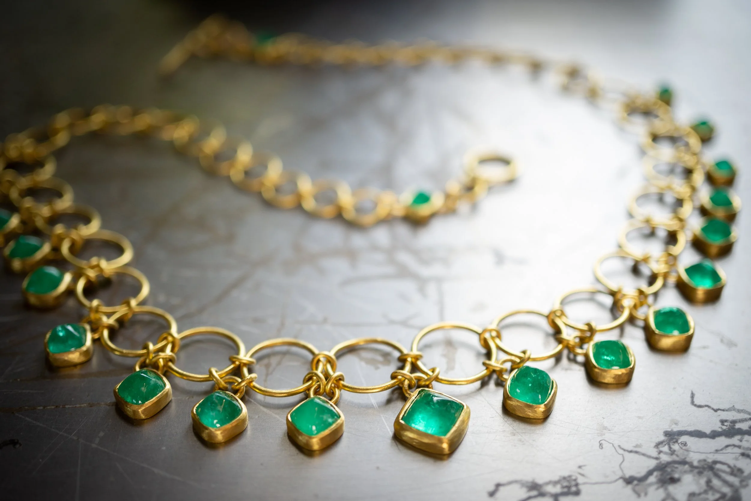 The Euclidean Necklace in 22-karat gold and sugarloaf emeralds.