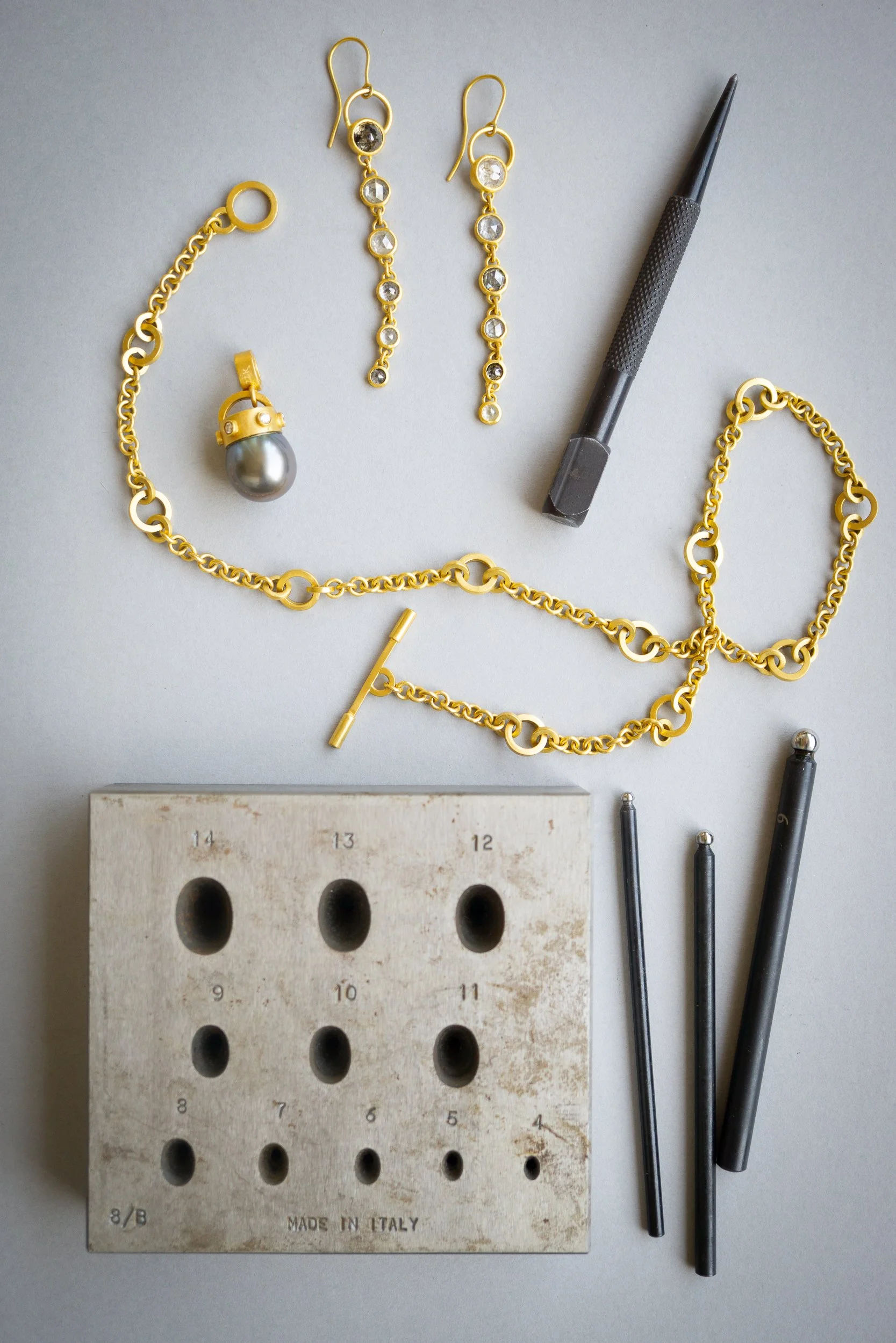 Dusk Earrings on table with Trinity Necklace and Diadem Charm.