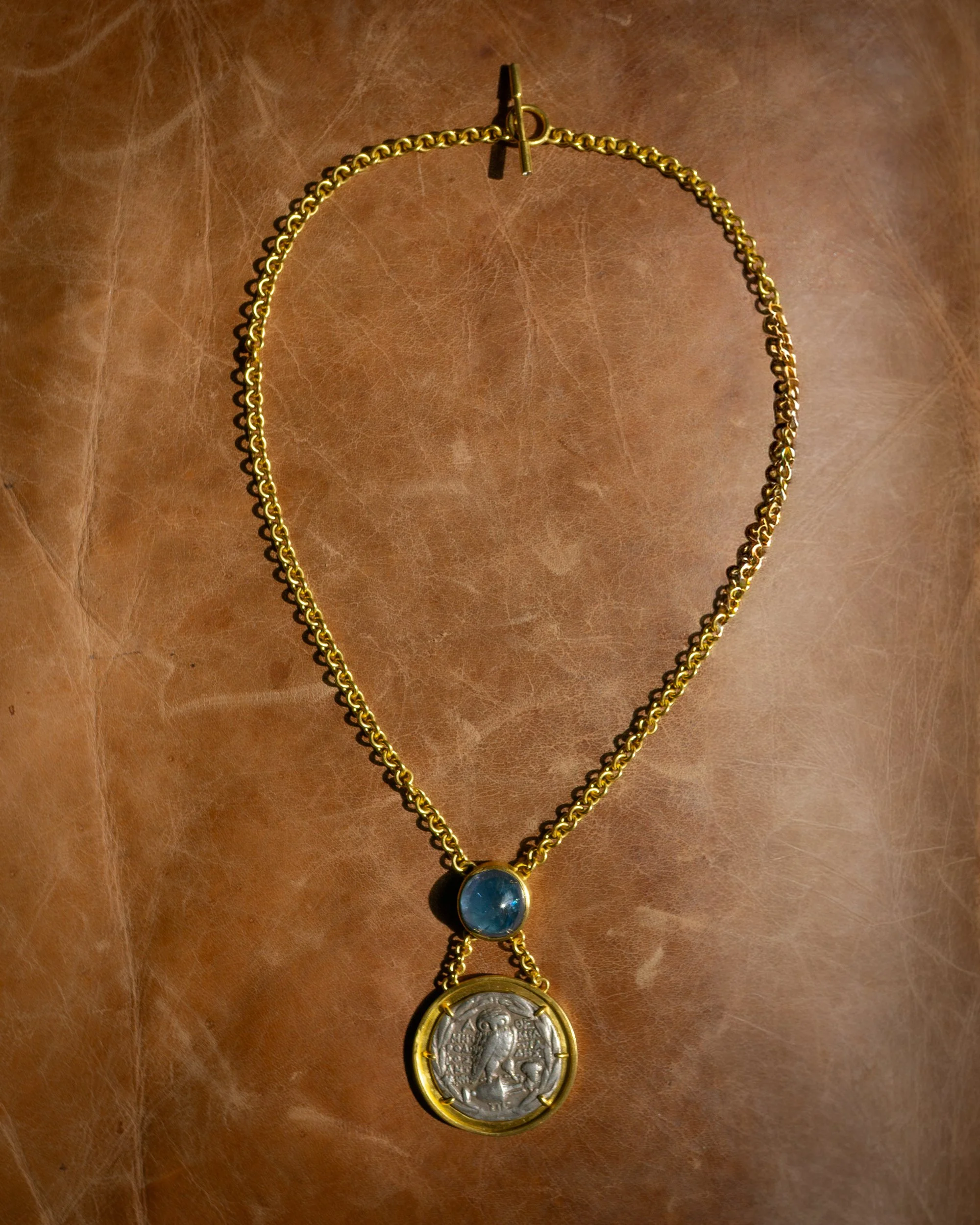 Aegean Necklace in 22k gold, ancient coin, Burma sapphire, and diamond.