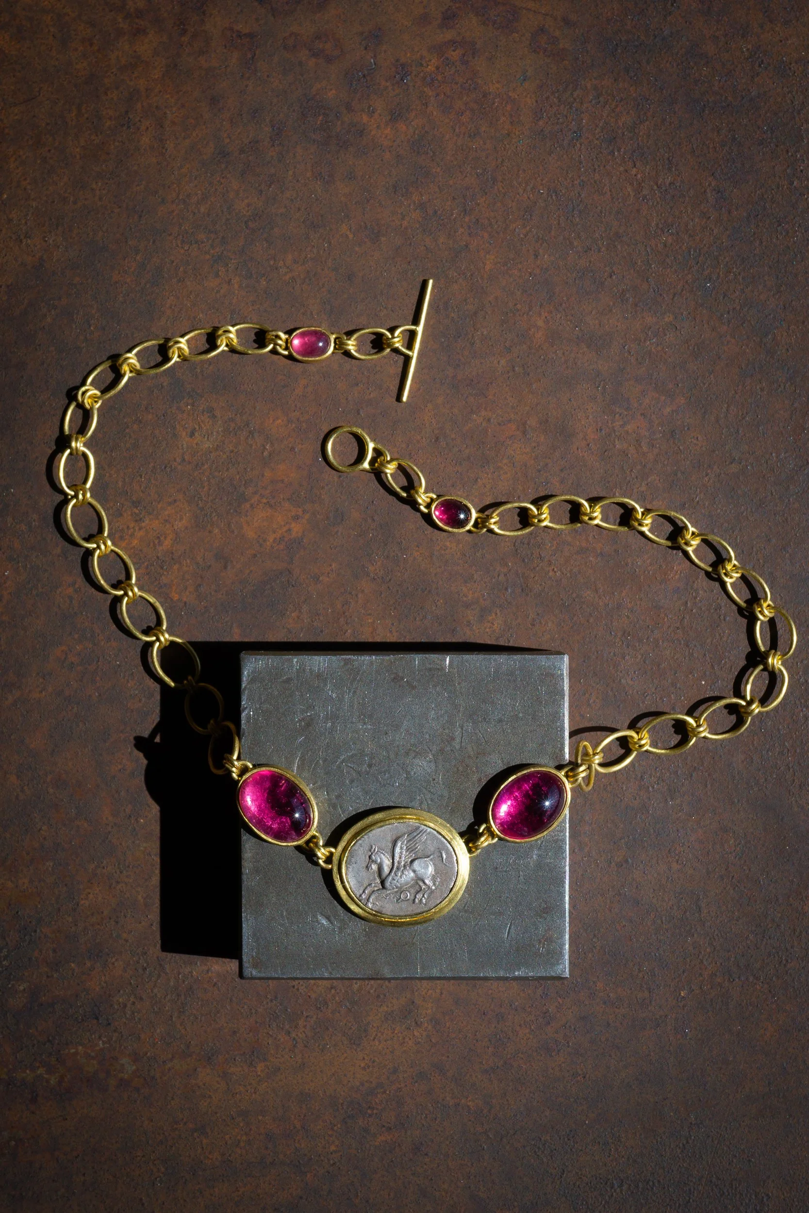 Pegasus Necklace in 22k gold, ancient coin of Pegasus, and rubellites.