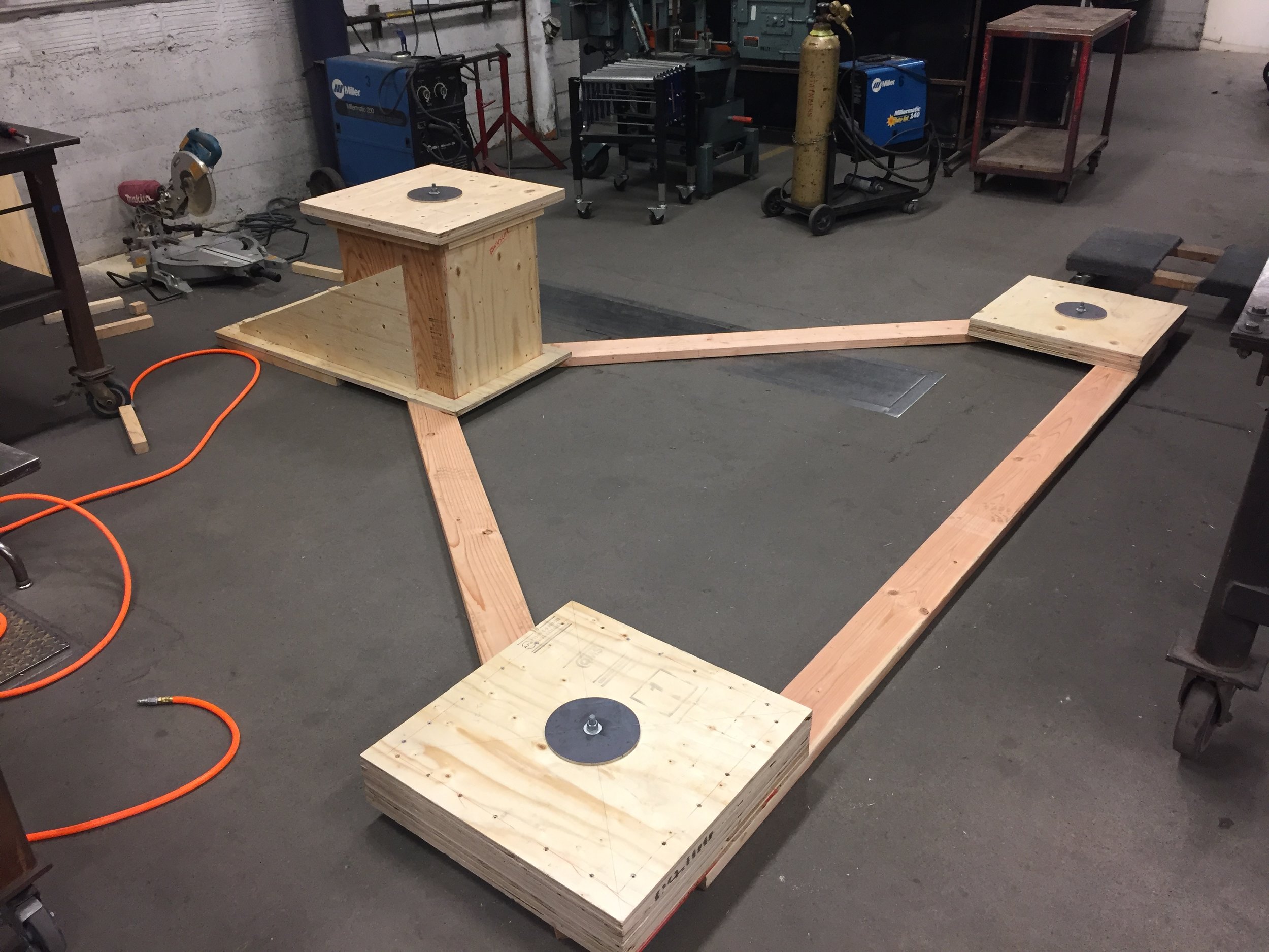 Mounting cradle fabricated to emulate footing anchor bolt layout and their respective elevations