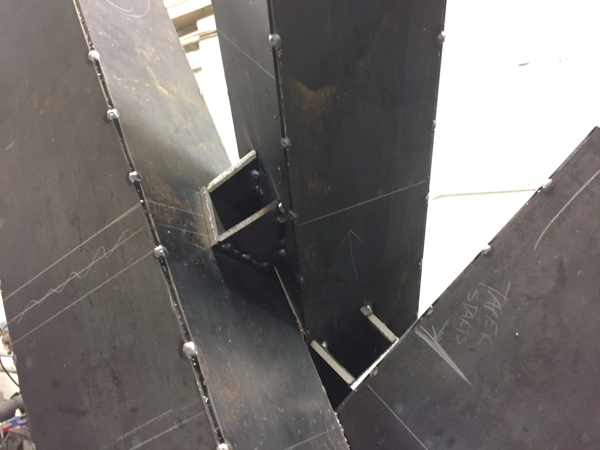 Wedge shoes tacked into place to receive bolts attaching the central upright to the cross members