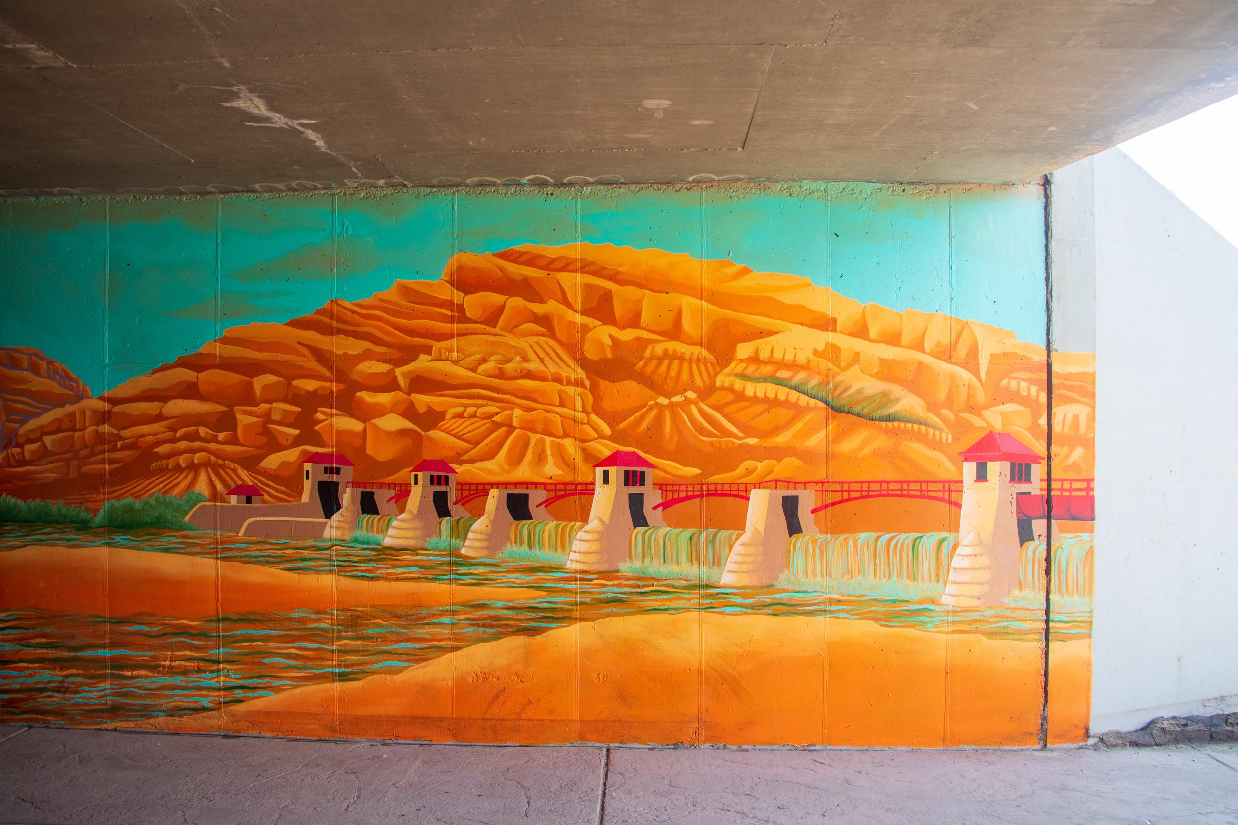  As the viewer returns to Fruita along the east wall, they begin to have an opposite effect, actively healing the landscape as they move back through the tunnel. Water again flows through the roller dam, and new growth sprouts up in the burn scar lef