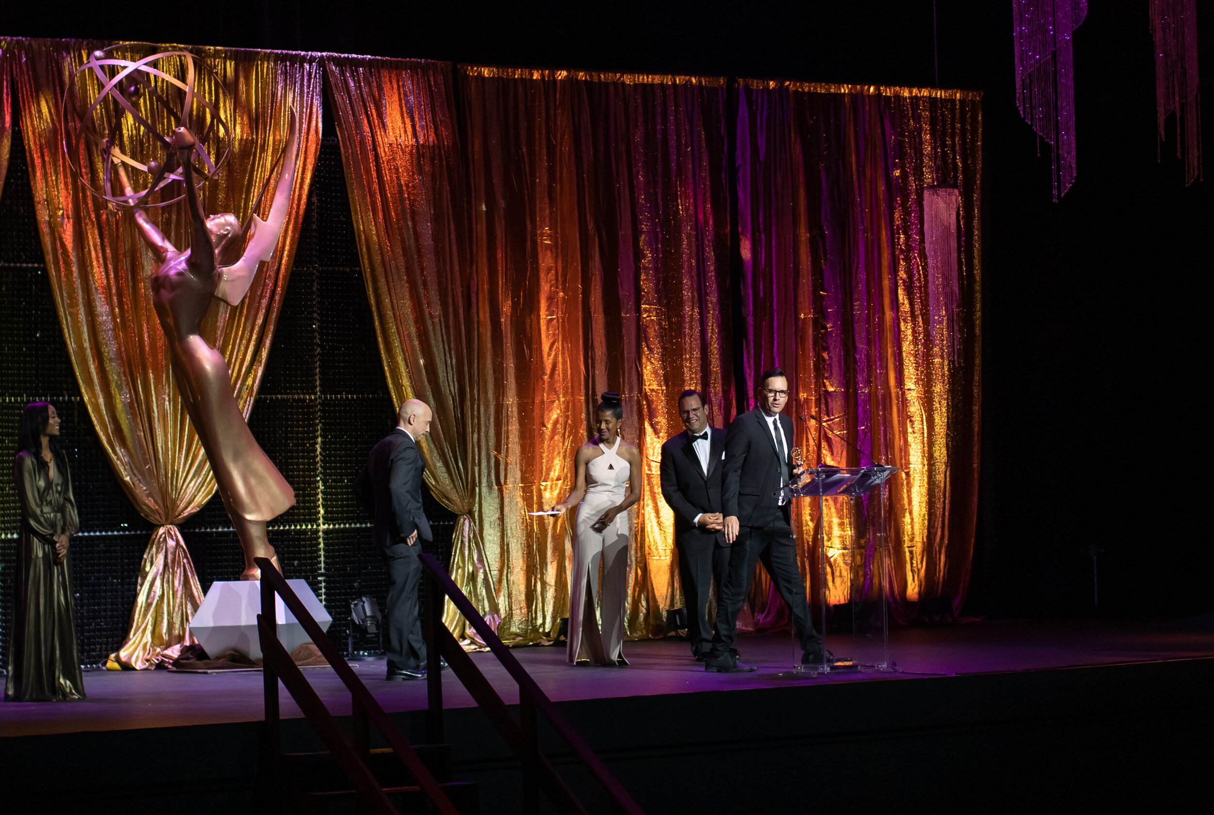  Pop Mod Photo co-owner Ryan Garza takes the stage to accept his EMMY award for documentary video work for the Detroit Free Press. 